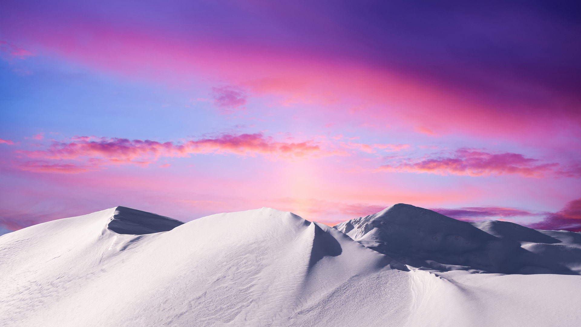 Snowy mountains under a vibrant sunset sky HD Wallpaper
