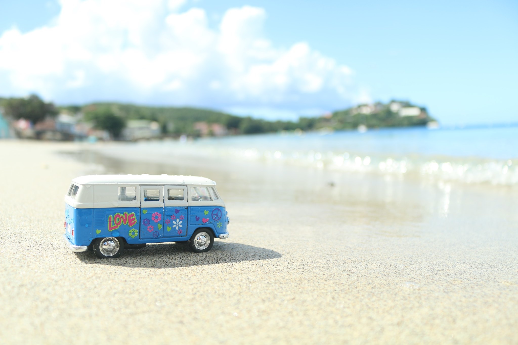 Blue Volkswagen toy van on a beach HD Wallpaper