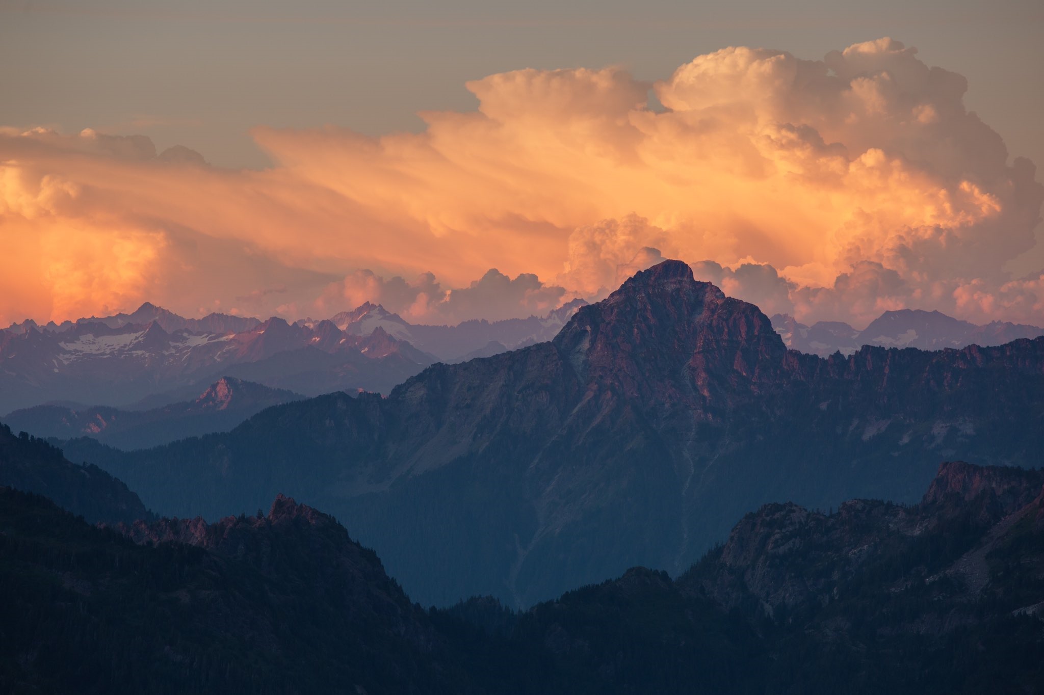 Sunset glow over layered mountains and clouds HD Wallpaper
