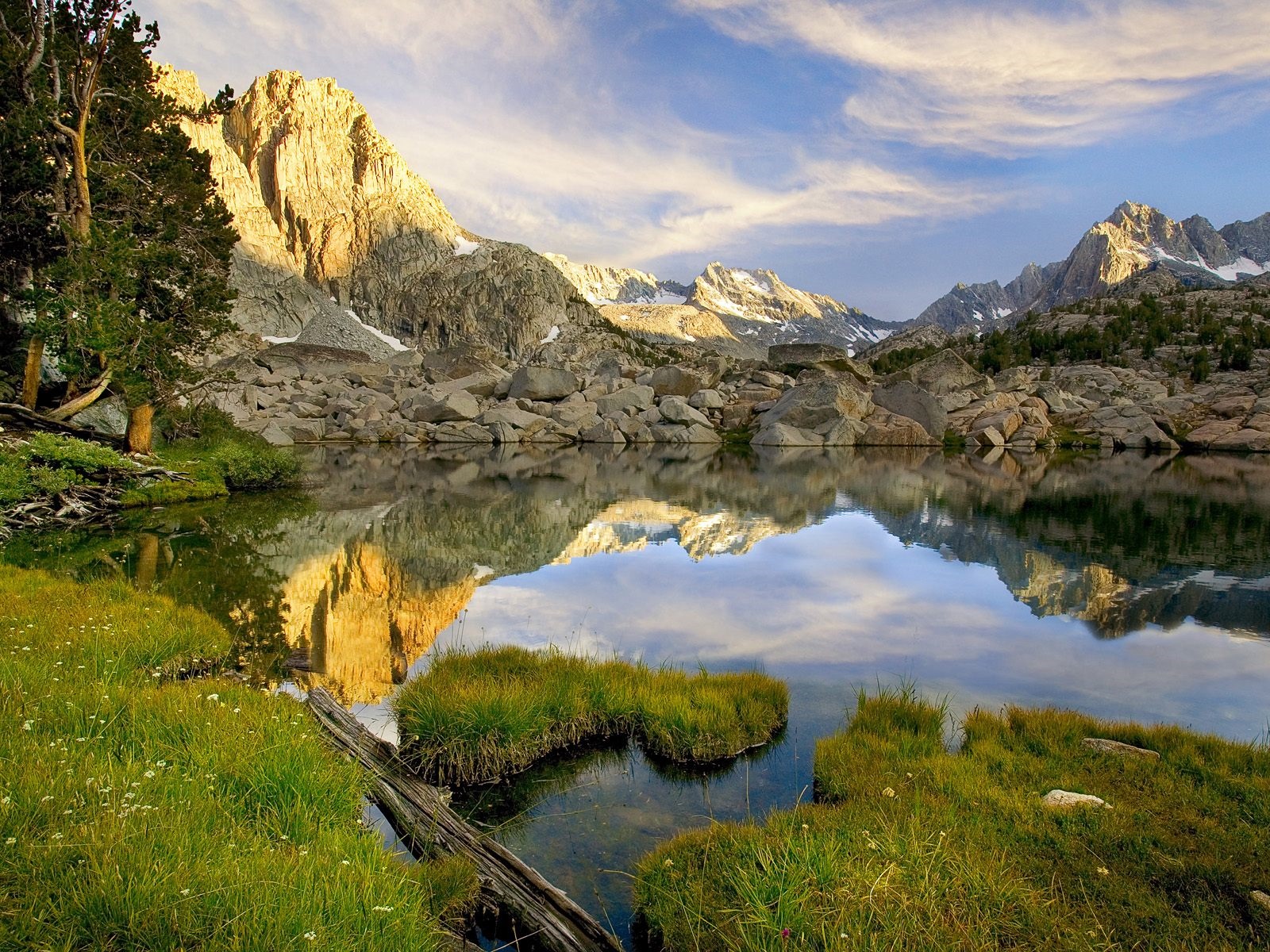 Mountain lake reflection with grass and rocks HD Wallpaper