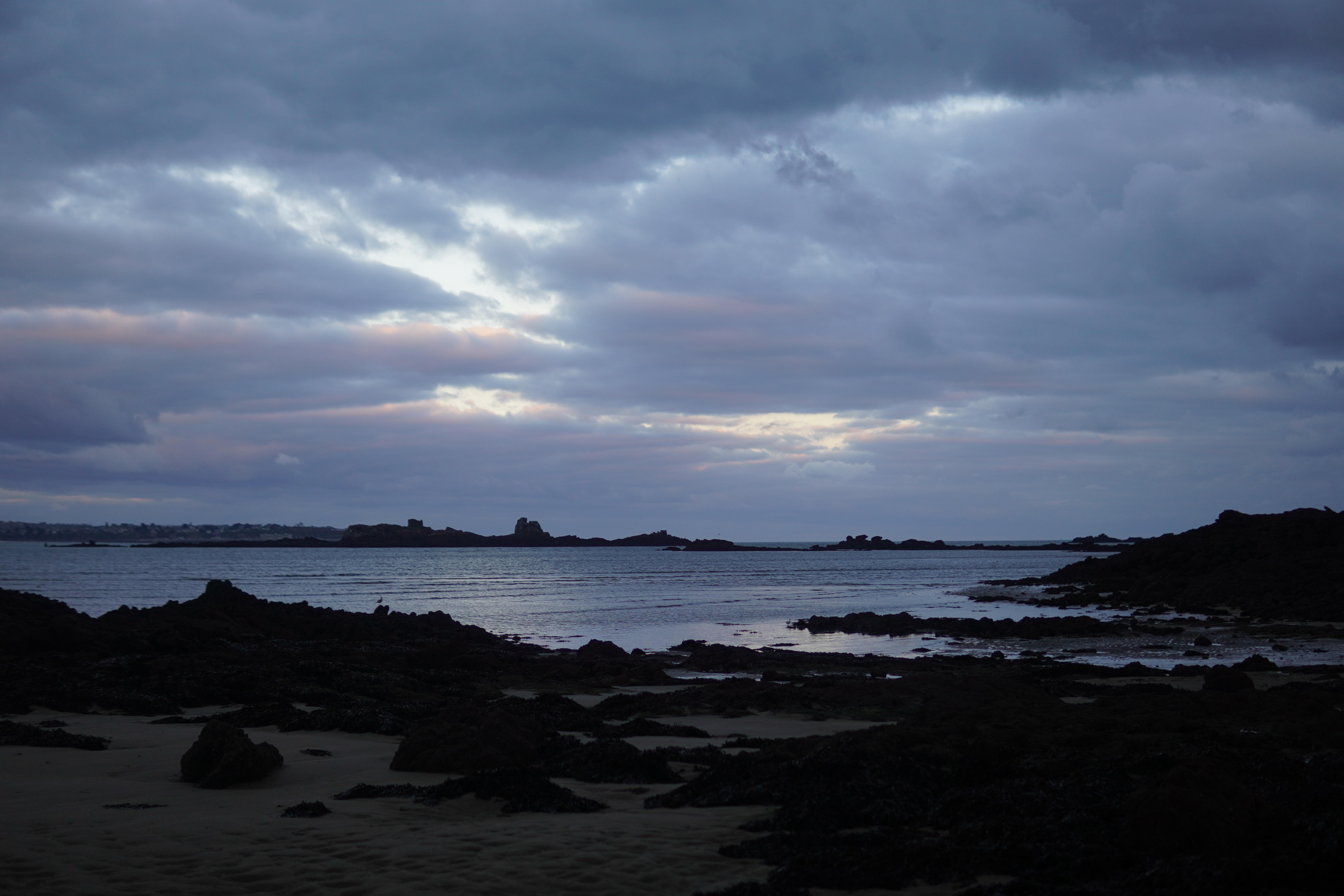 Brittany coast with rocky shore and cloudy sky HD Wallpaper