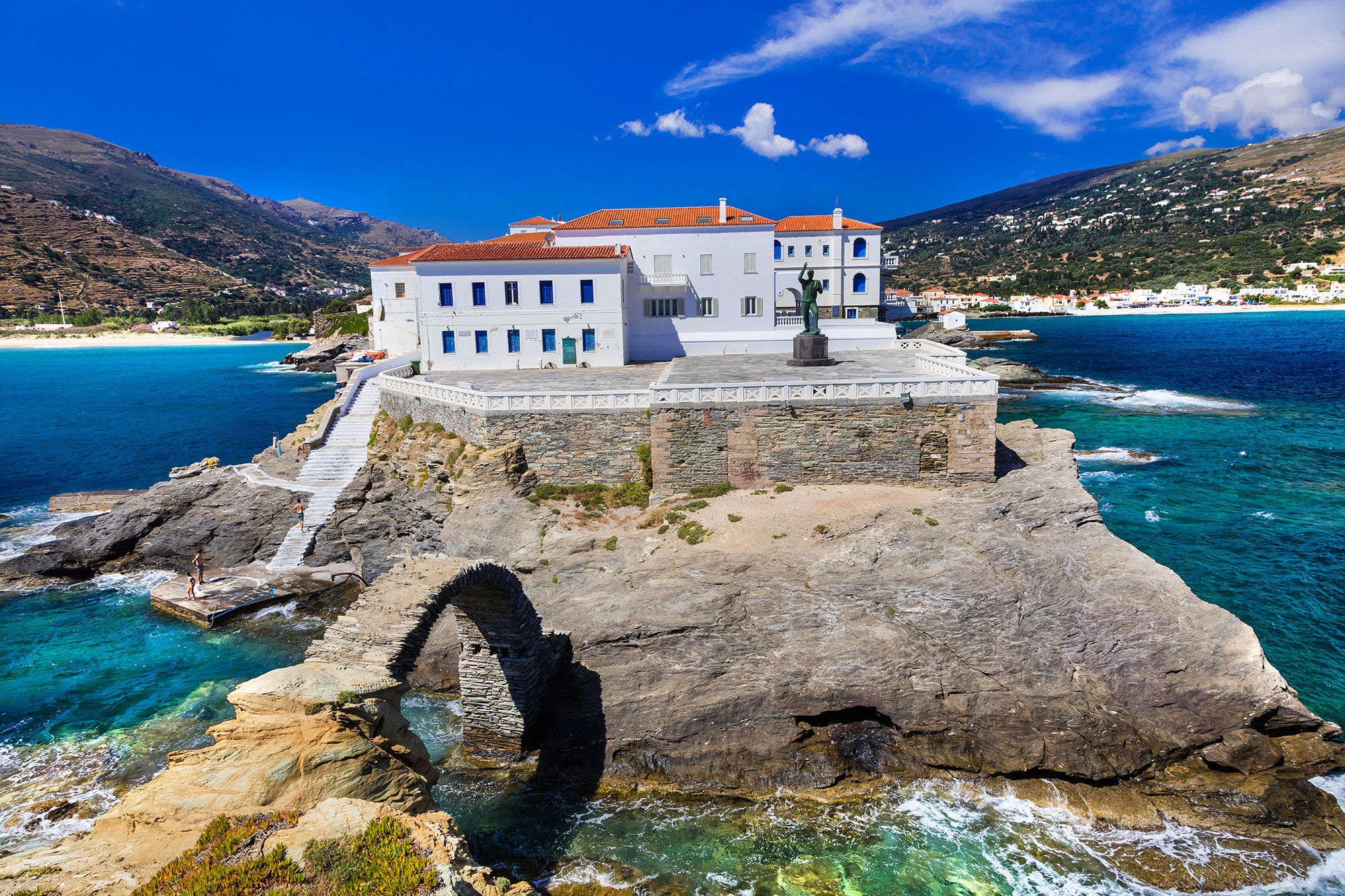 White building on a rocky island in Andros, Greece HD Wallpaper