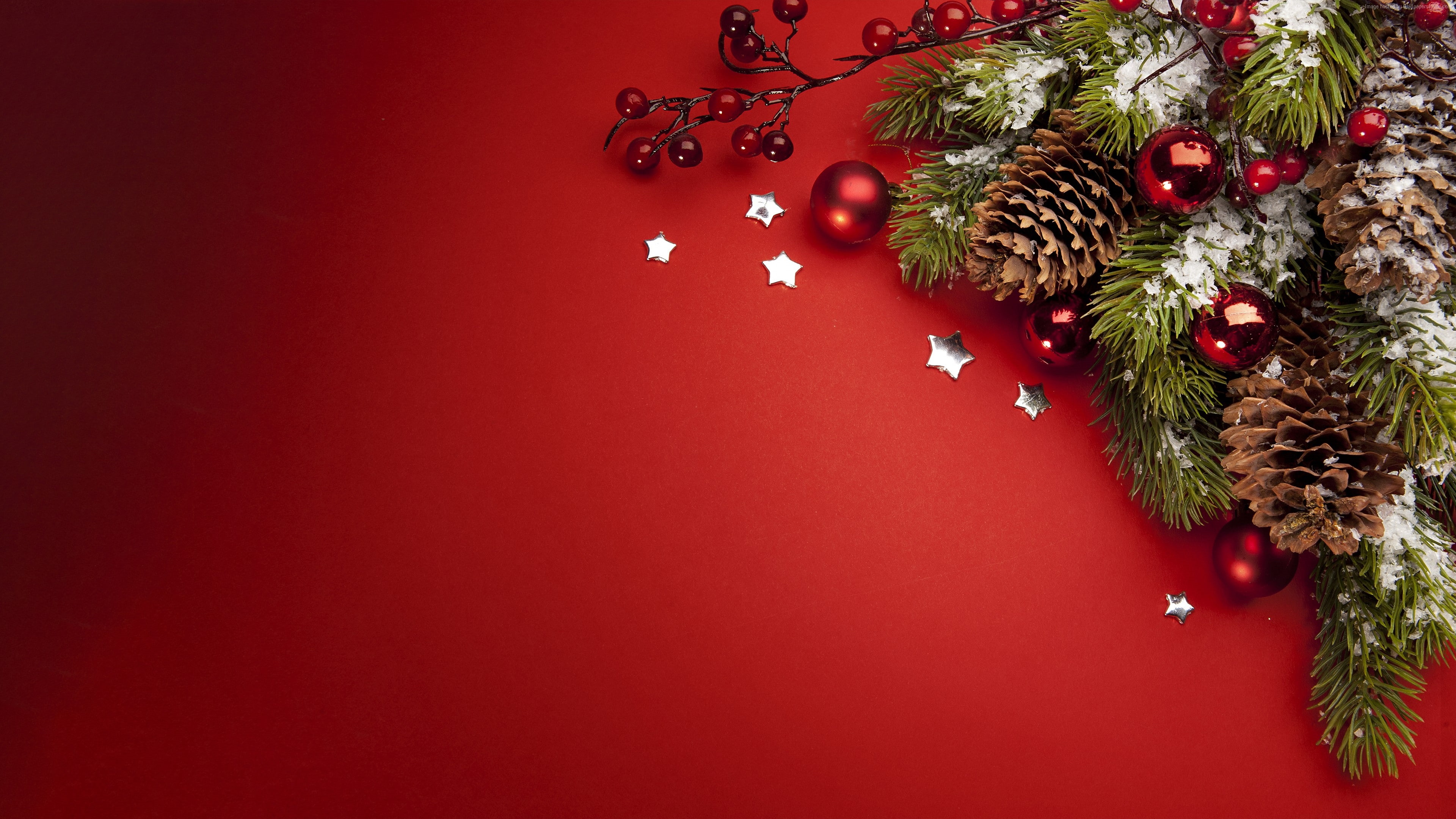 Christmas ornaments and pine cones on red background HD Wallpaper