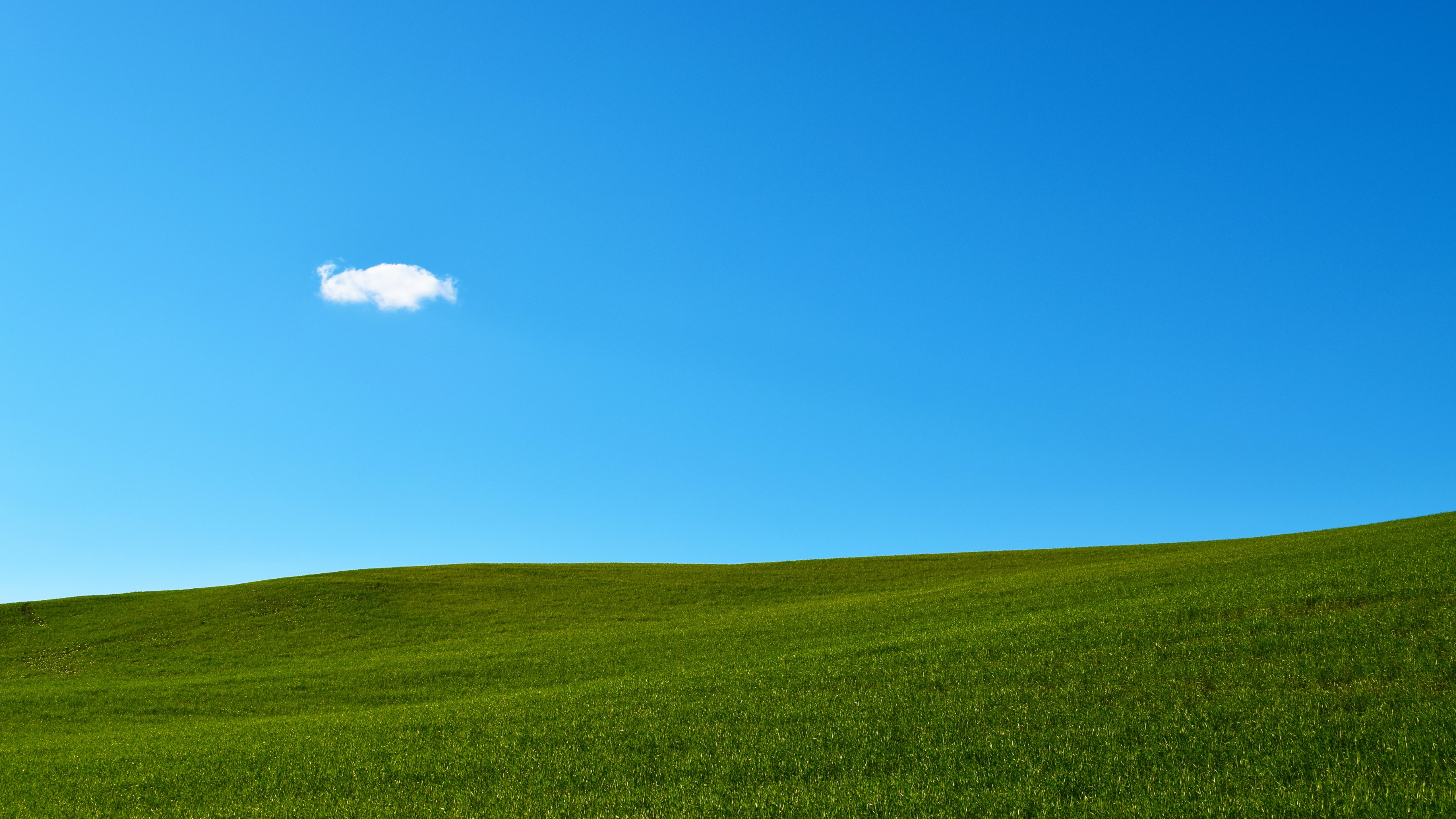 4K landscape of green hills under a blue sky HD Wallpaper