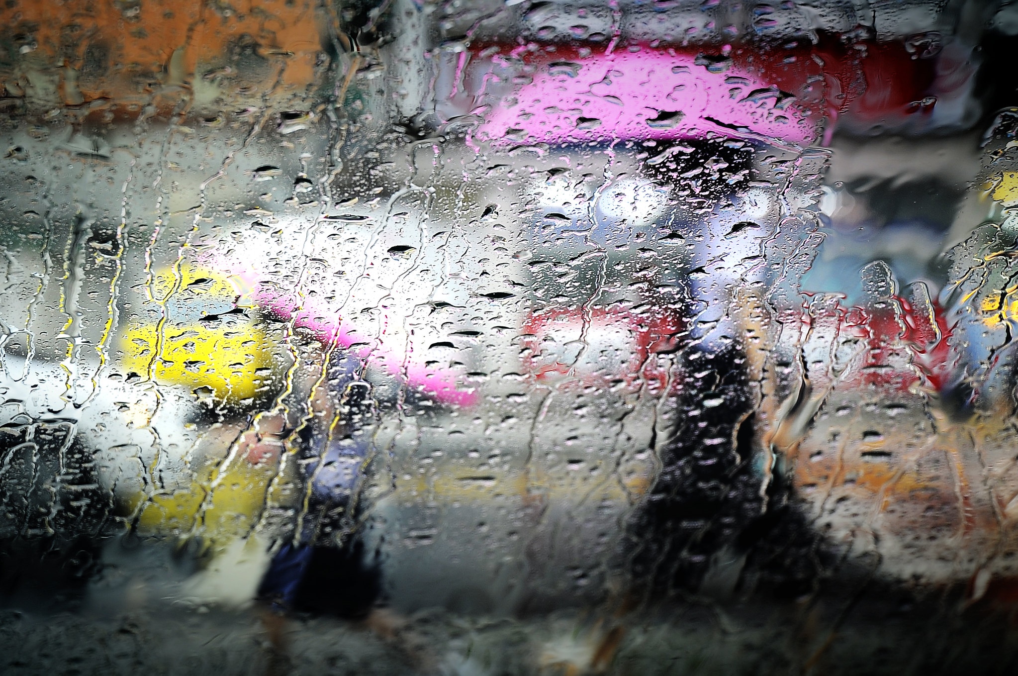 People with umbrellas in the rain on a street HD Wallpaper