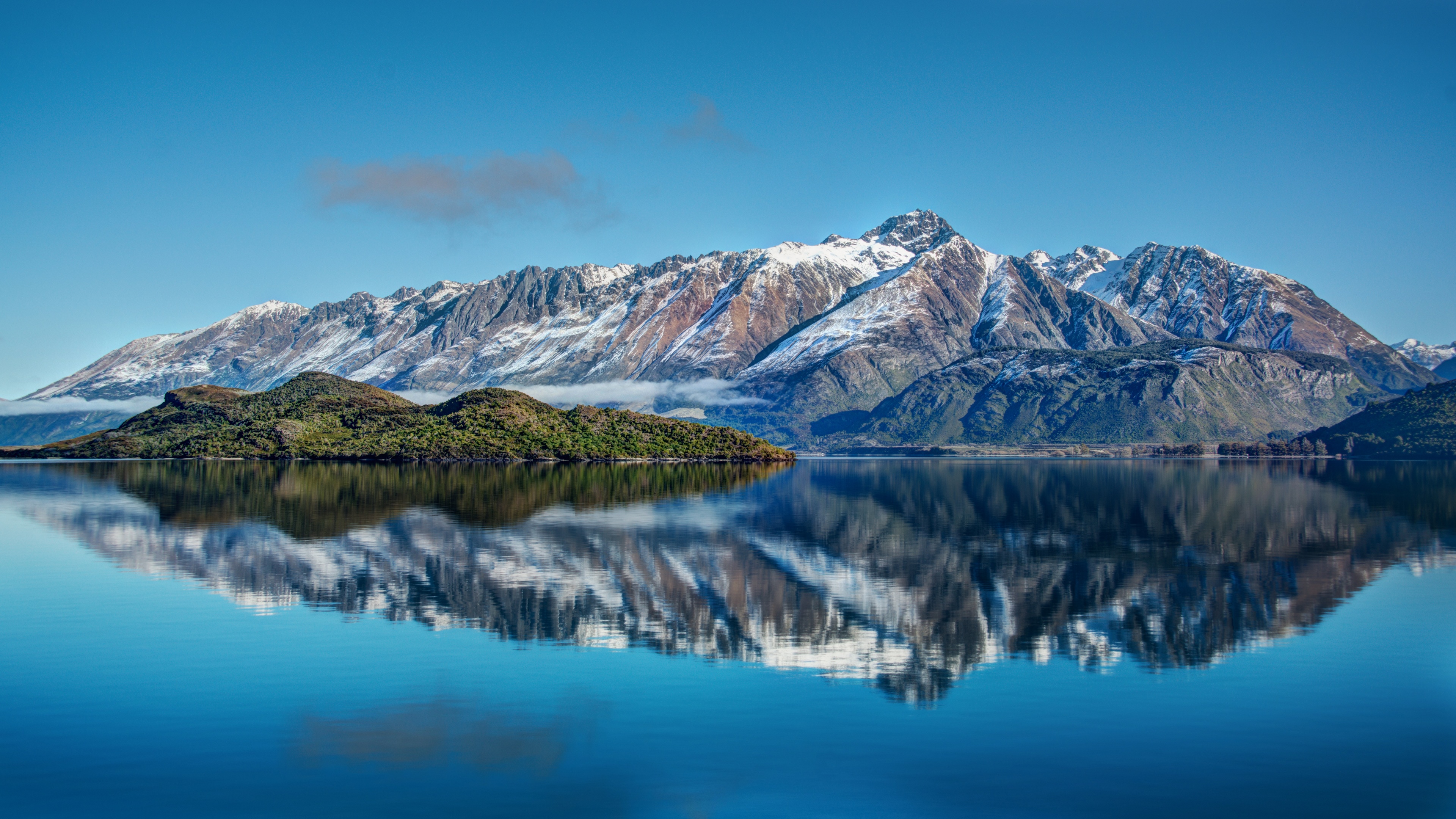 Snow-capped mountains reflected in a lake in New Zealand HD Wallpaper