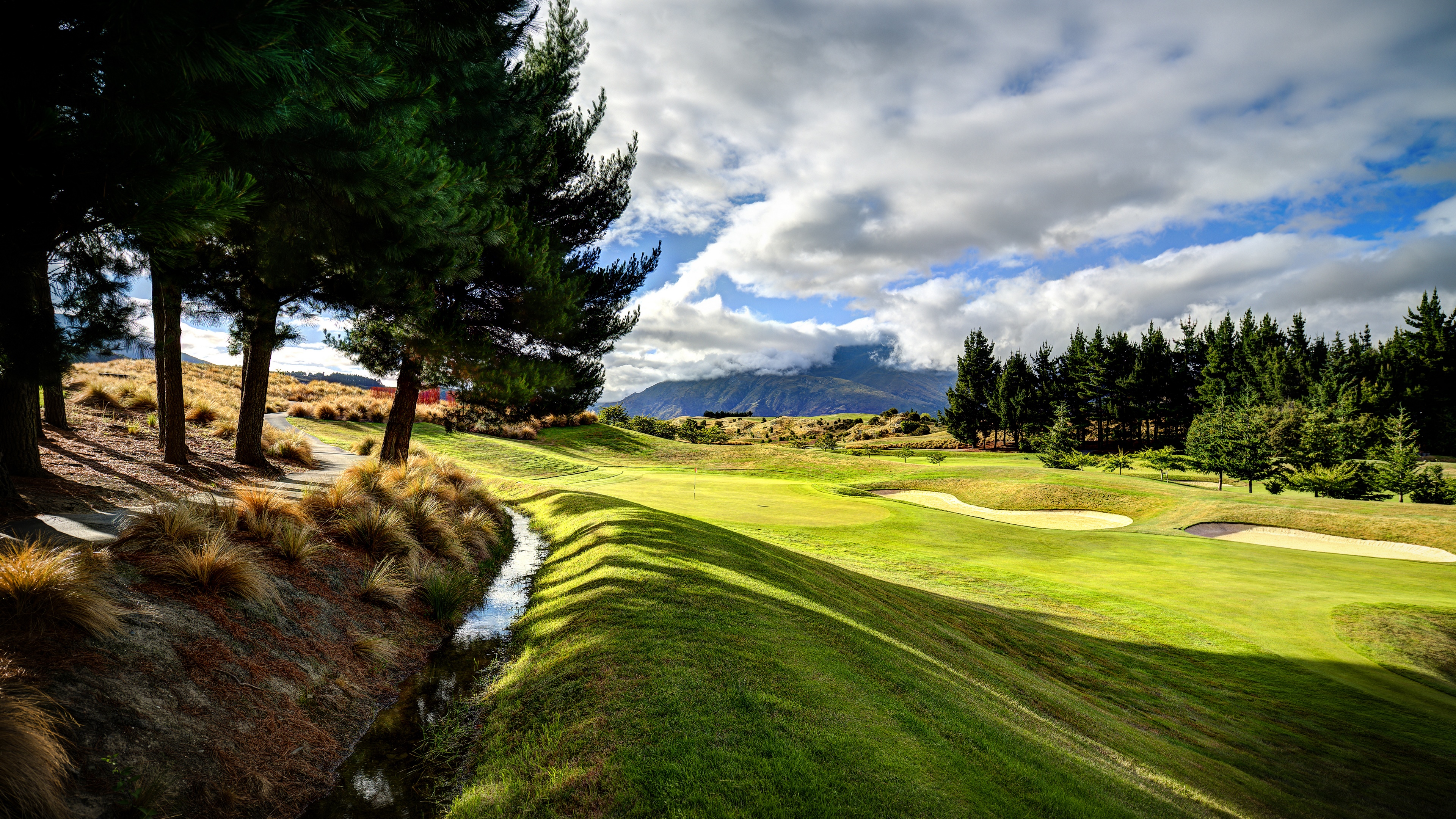 4K New Zealand Golf Course Landscape with Trees and Mountains HD Wallpaper