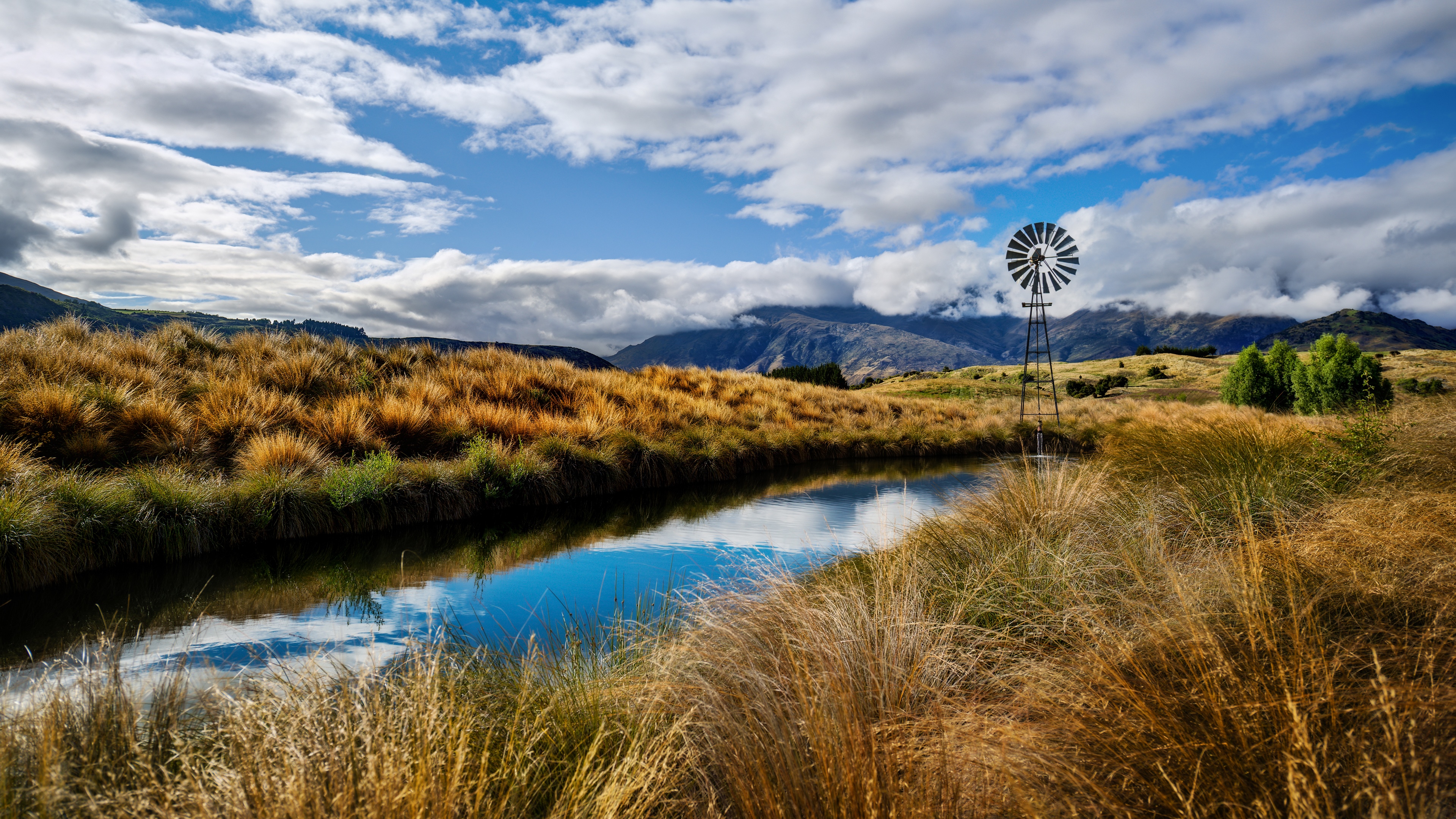 4K New Zealand Landscape with Windmill and Water HD Wallpaper