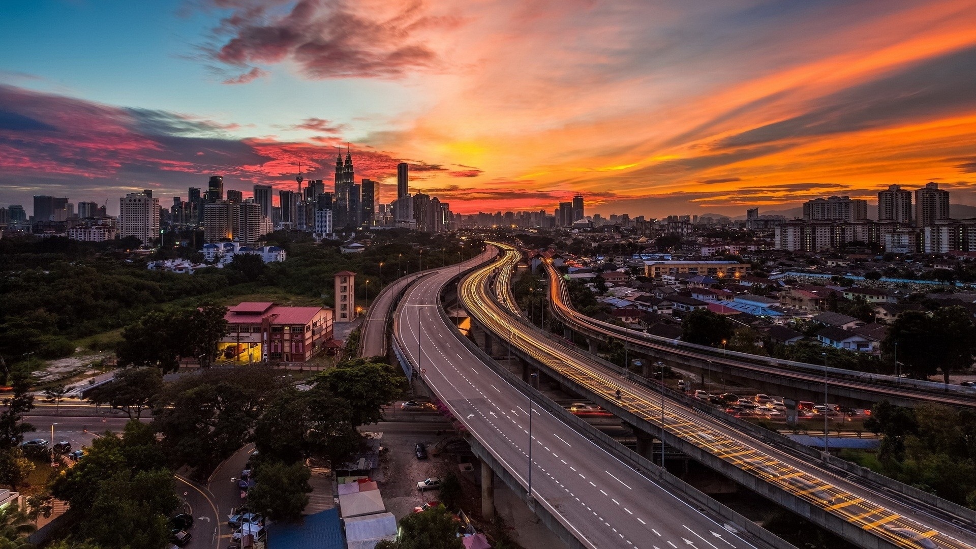 Cityscape with highway during sunset HD Wallpaper