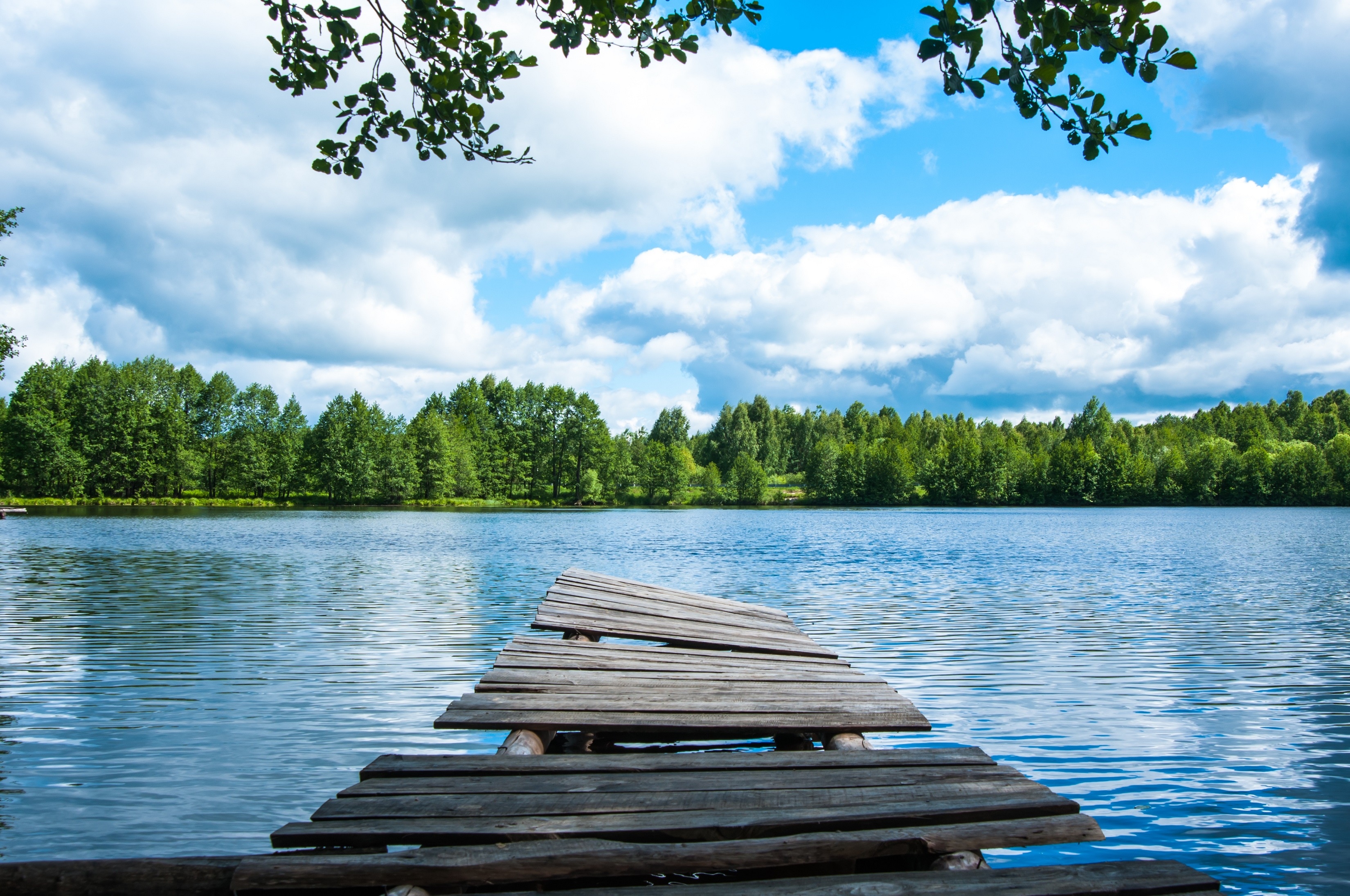 Wooden pier on a lake with trees and clouds HD Wallpaper