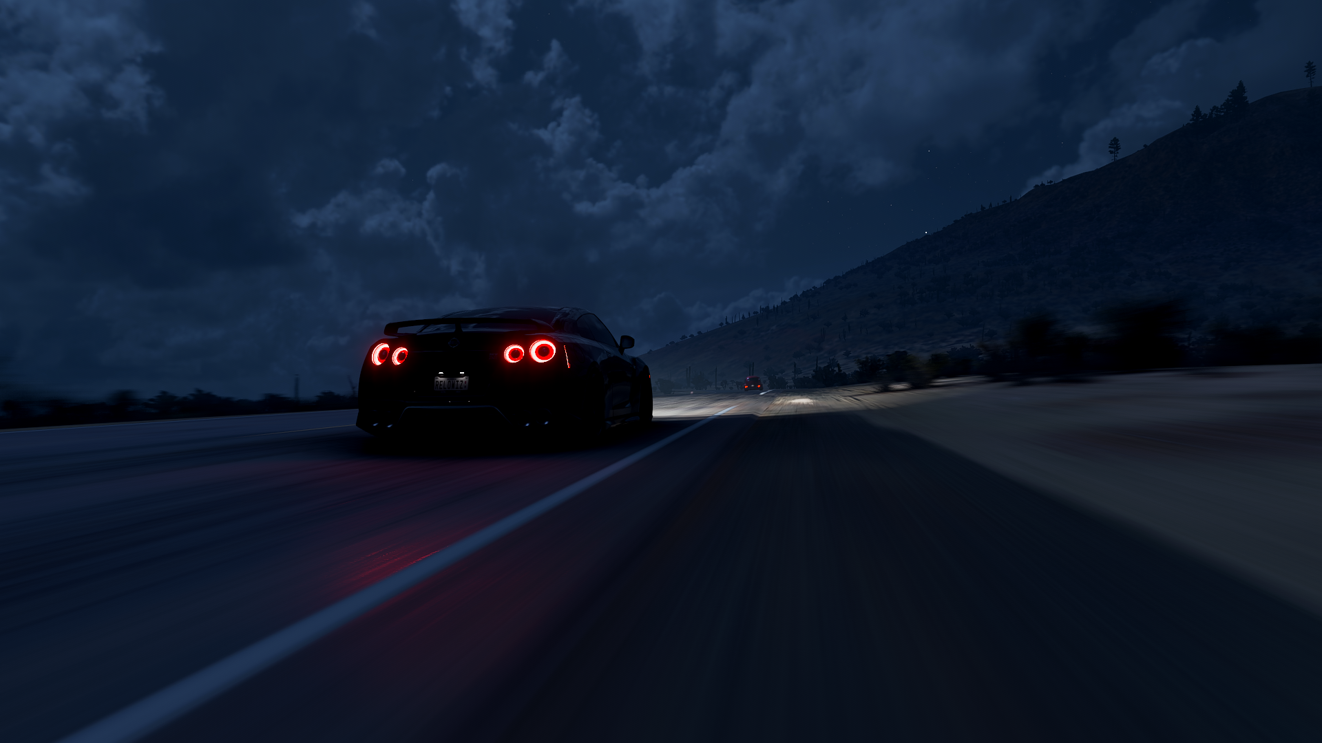 Nissan GT-R driving on a road at night in Forza Horizon 5 HD Wallpaper