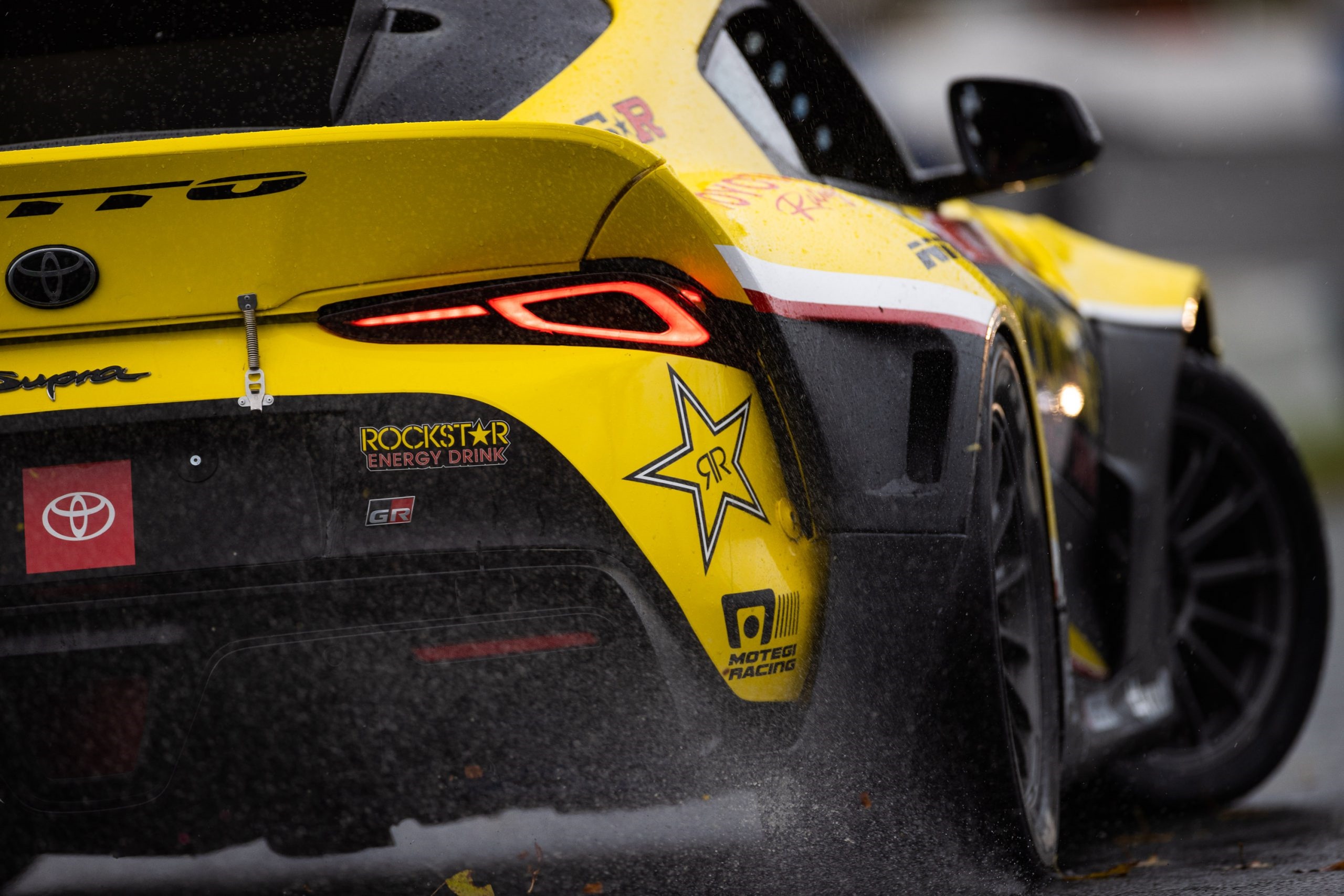 Yellow Toyota Supra race car with Rockstar Energy Drink sponsorship HD Wallpaper