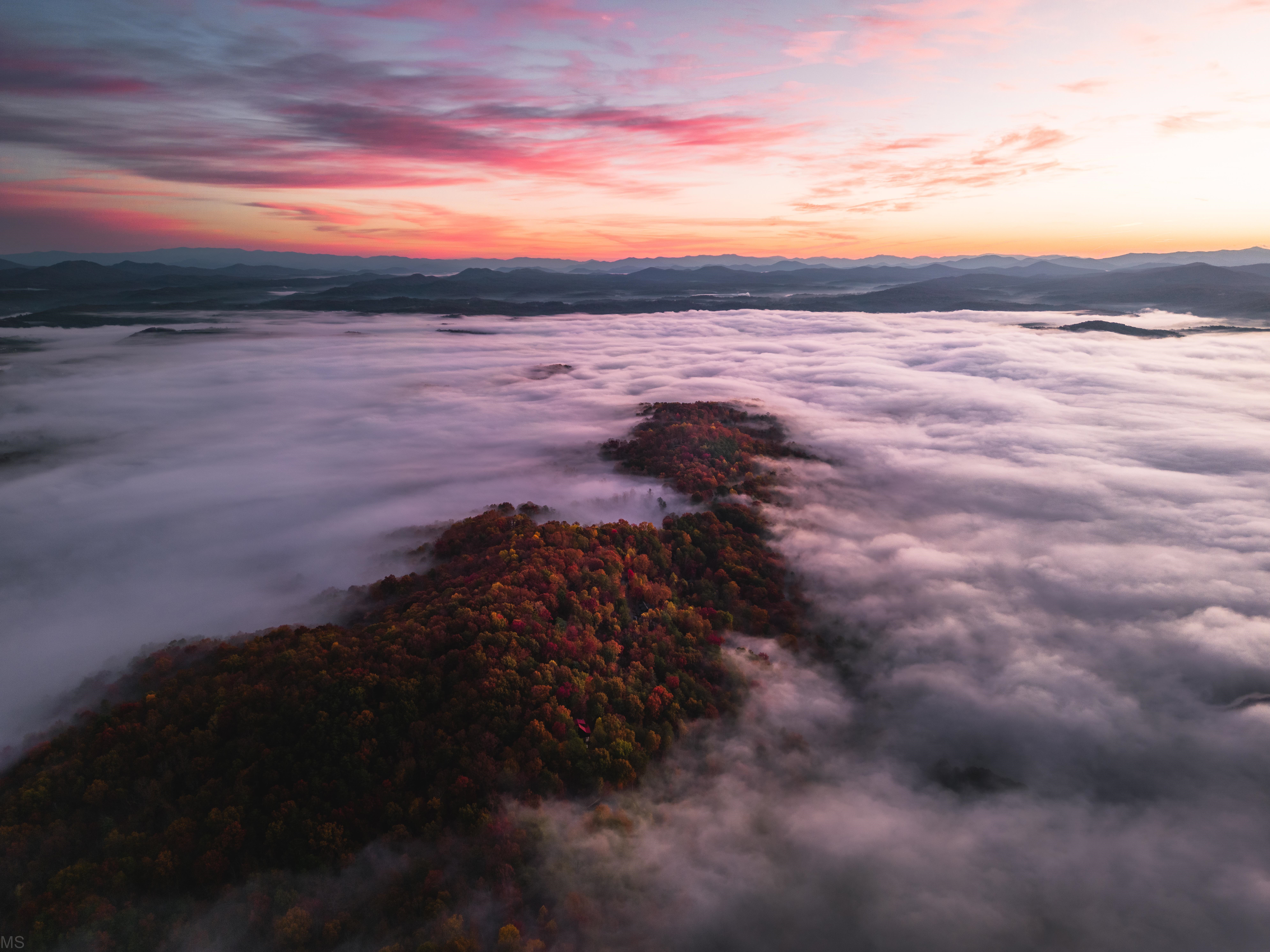 Aerial view of misty mountains at sunrise HD Wallpaper
