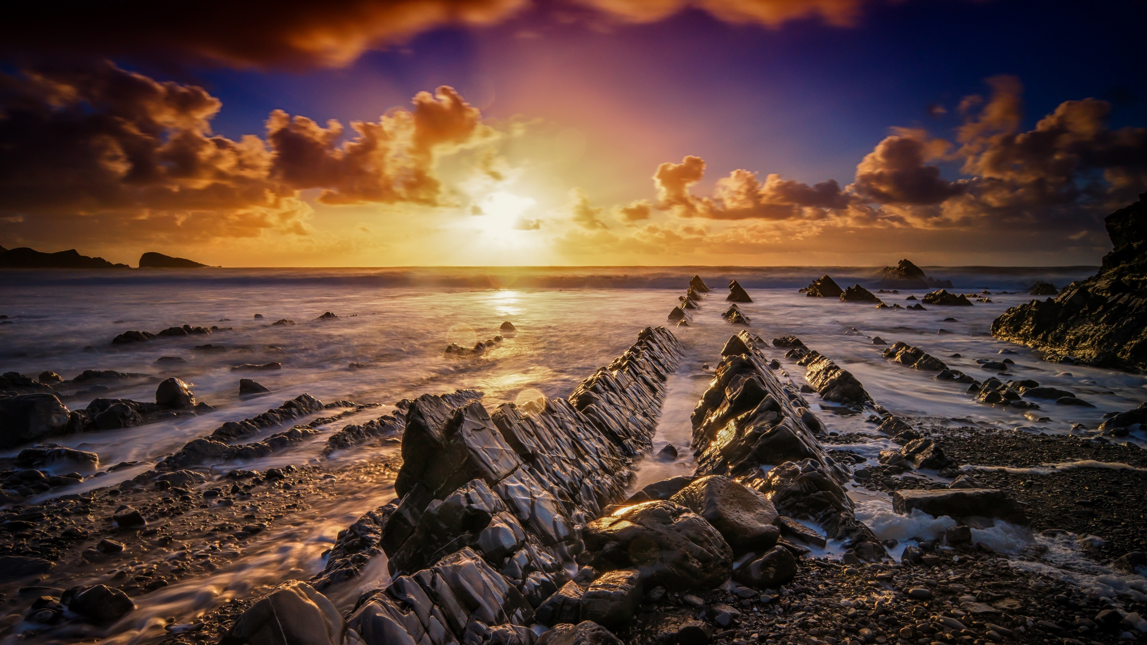 4K Sunset Over Rocky Coastline HD Wallpaper