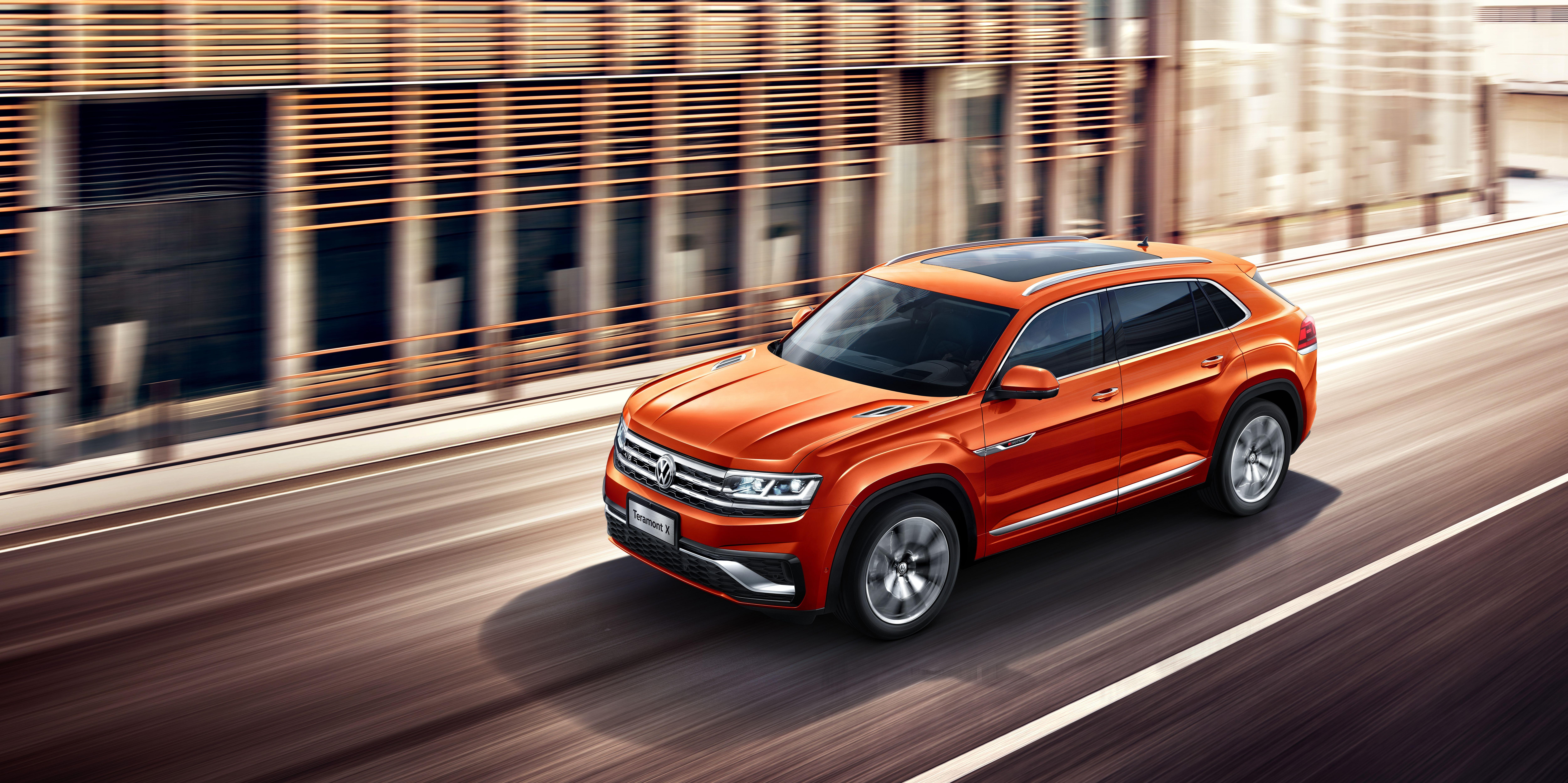 Orange Volkswagen Teramont SUV driving on a road HD Wallpaper