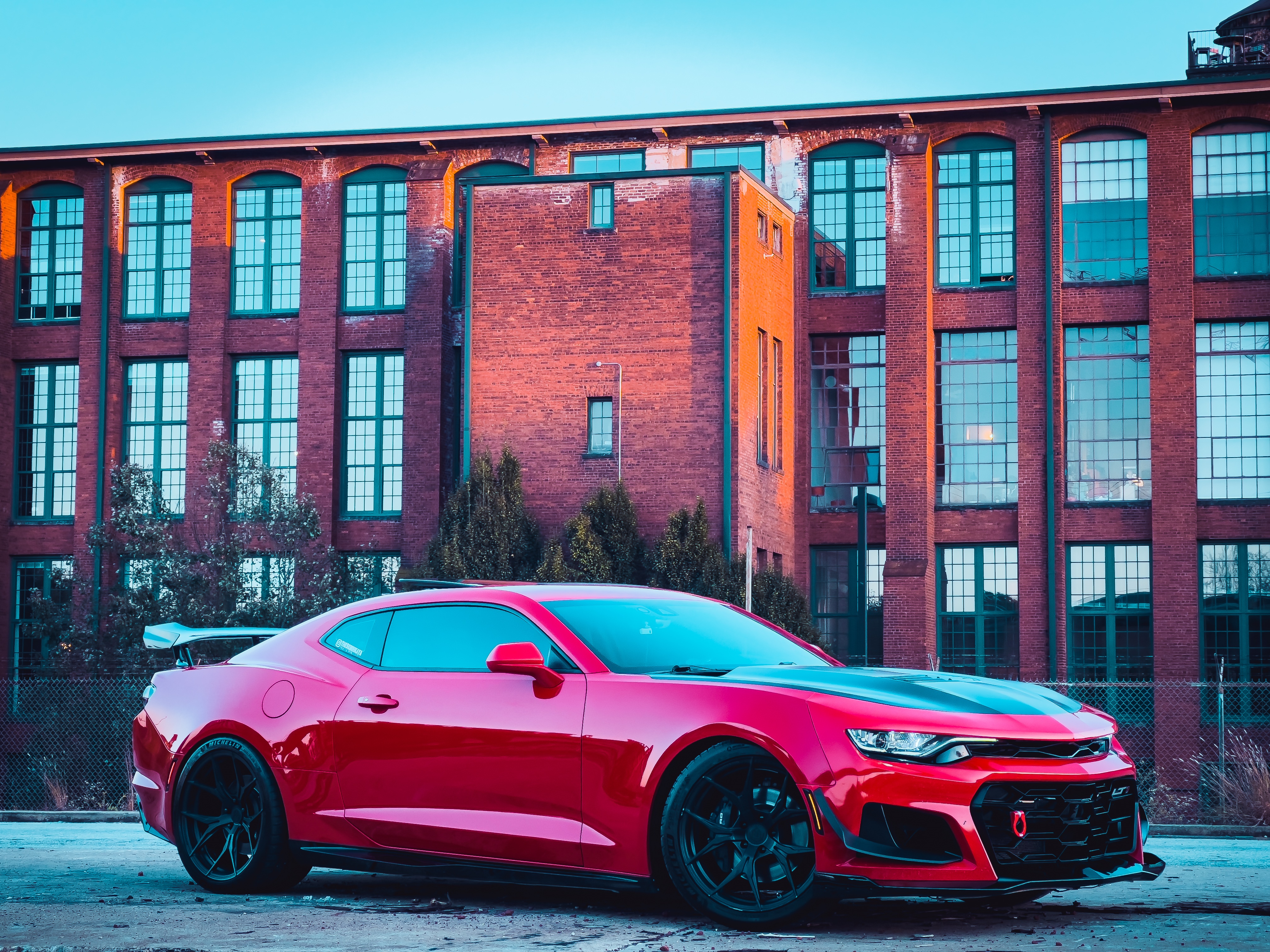 Red Chevrolet Camaro SS in front of brick building HD Wallpaper