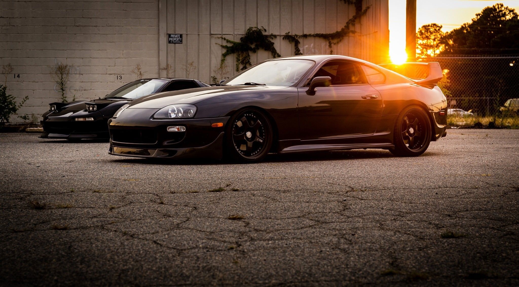 Two Japanese sports cars, Toyota Supra and Honda NSX, parked at sunset HD Wallpaper