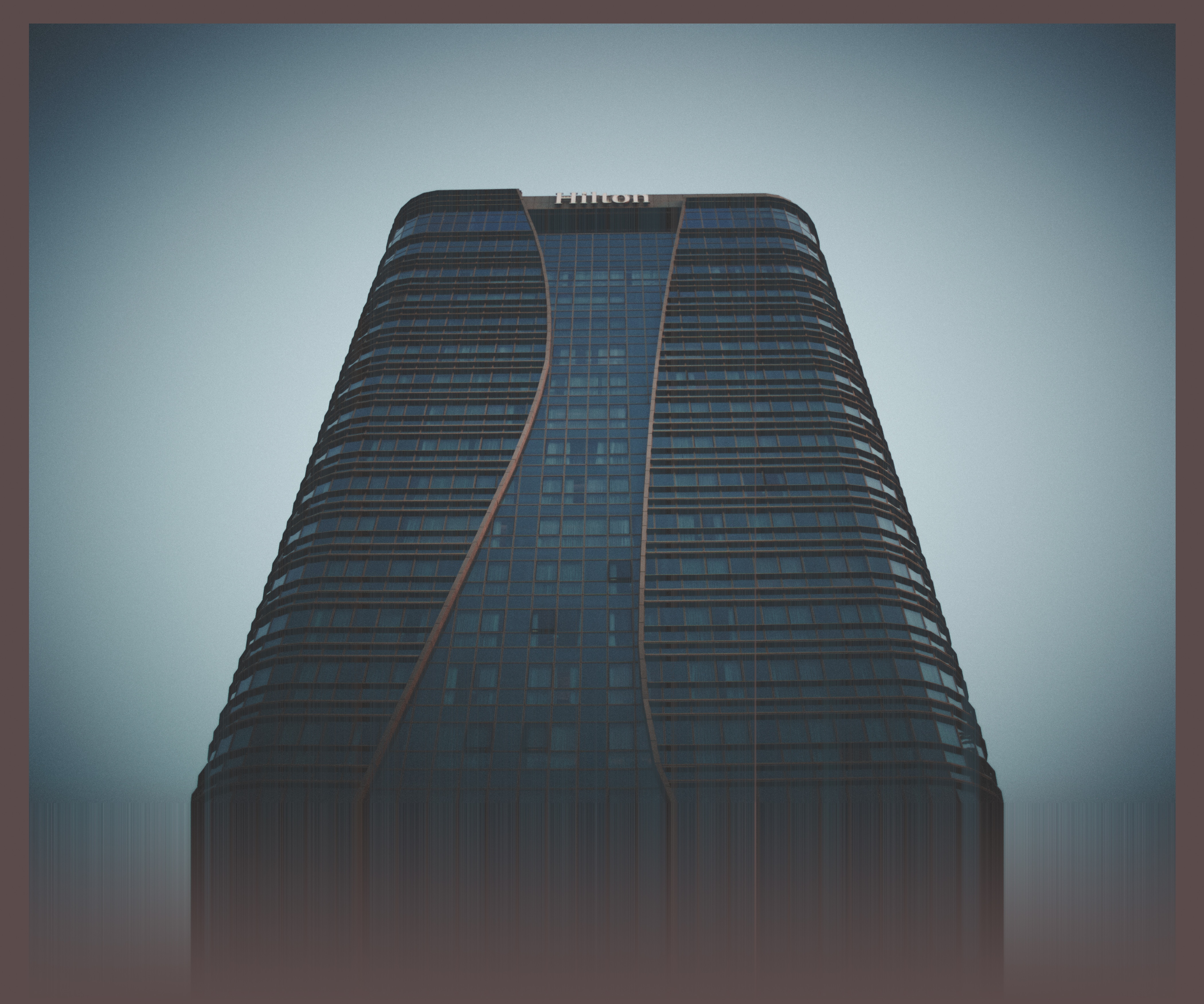 Hilton skyscraper building with glitch art effect HD Wallpaper