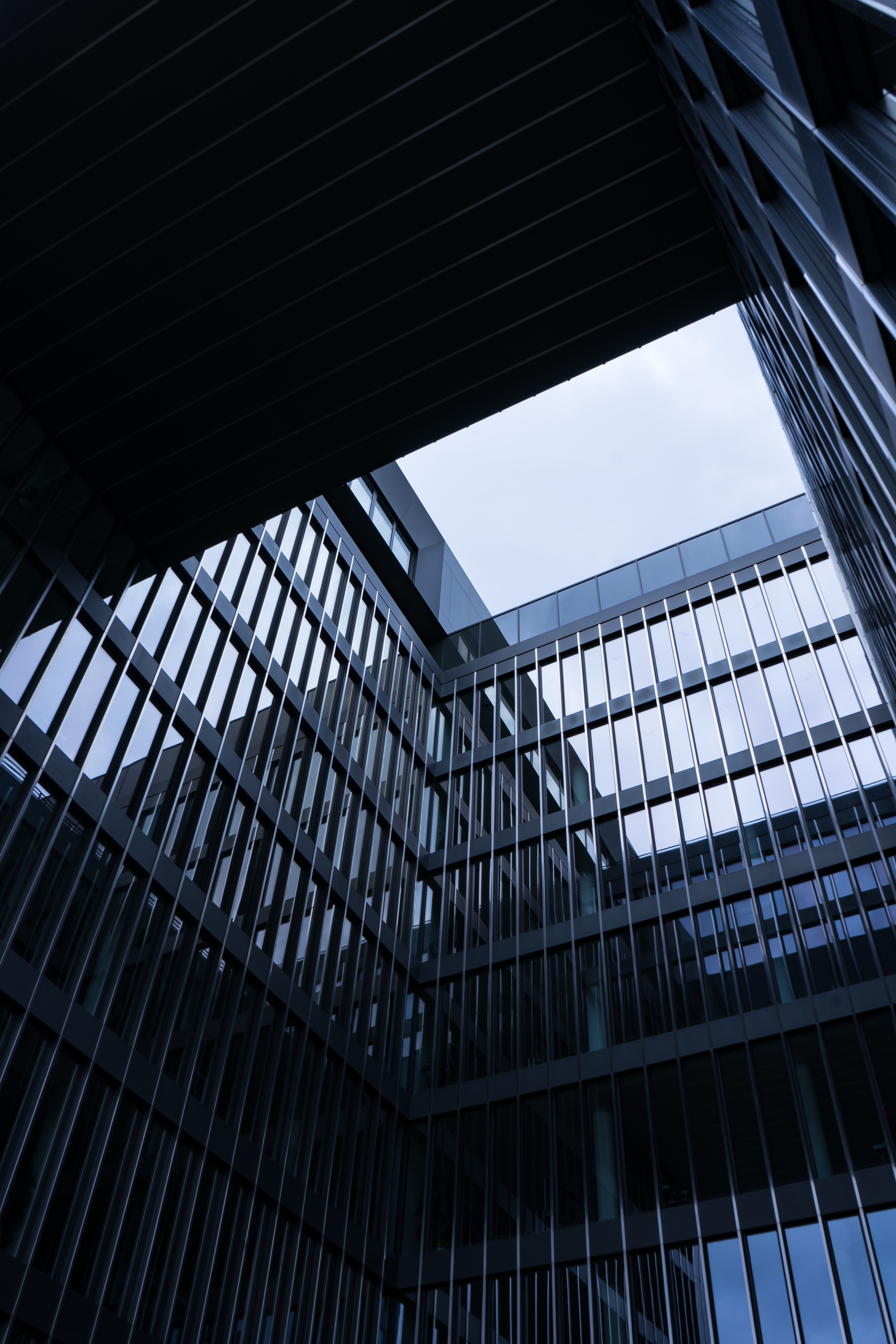 Modern architecture with glass facade and sky HD Phone Wallpaper