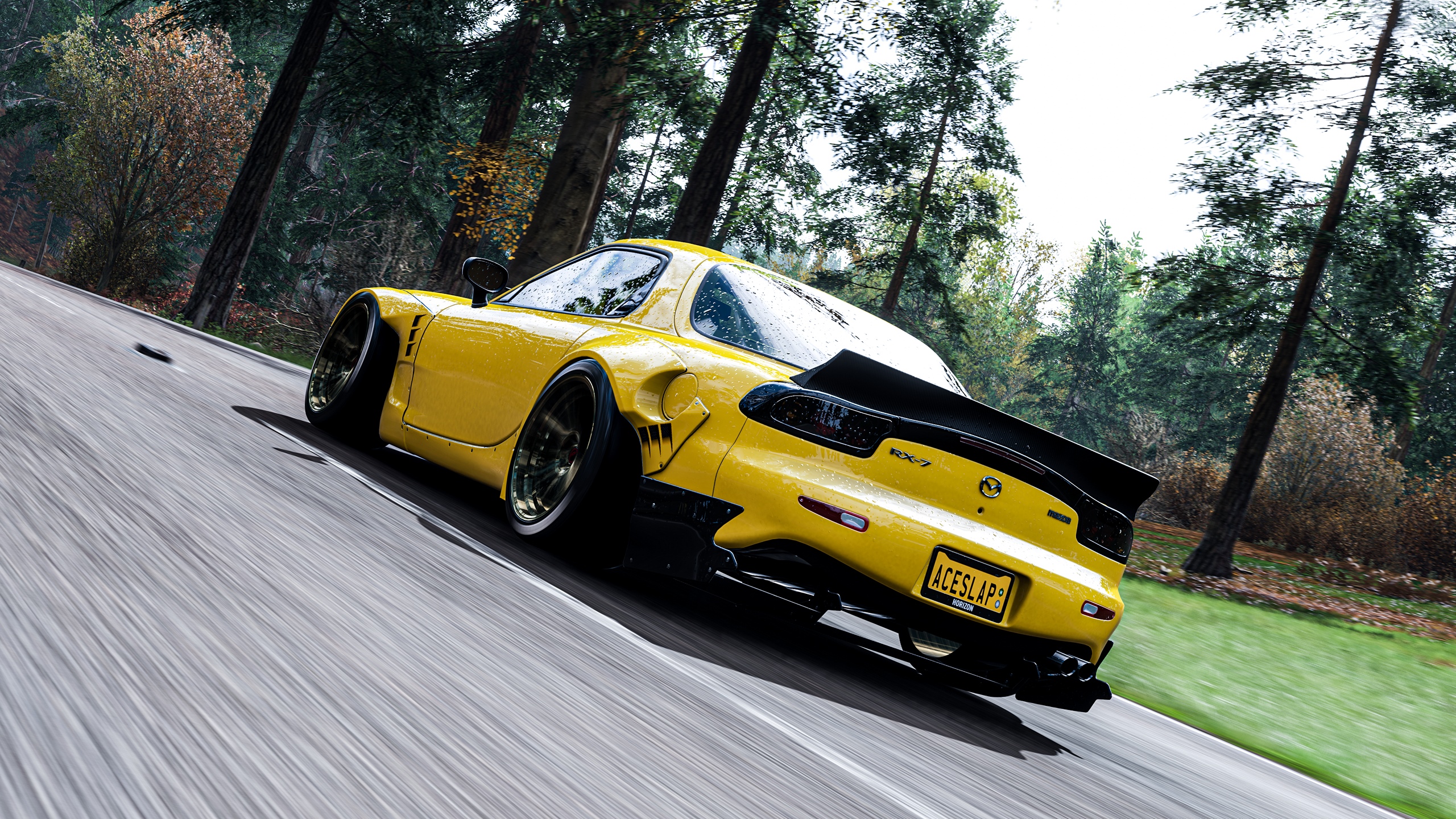 Yellow Mazda RX-7 driving on a forest road HD Wallpaper