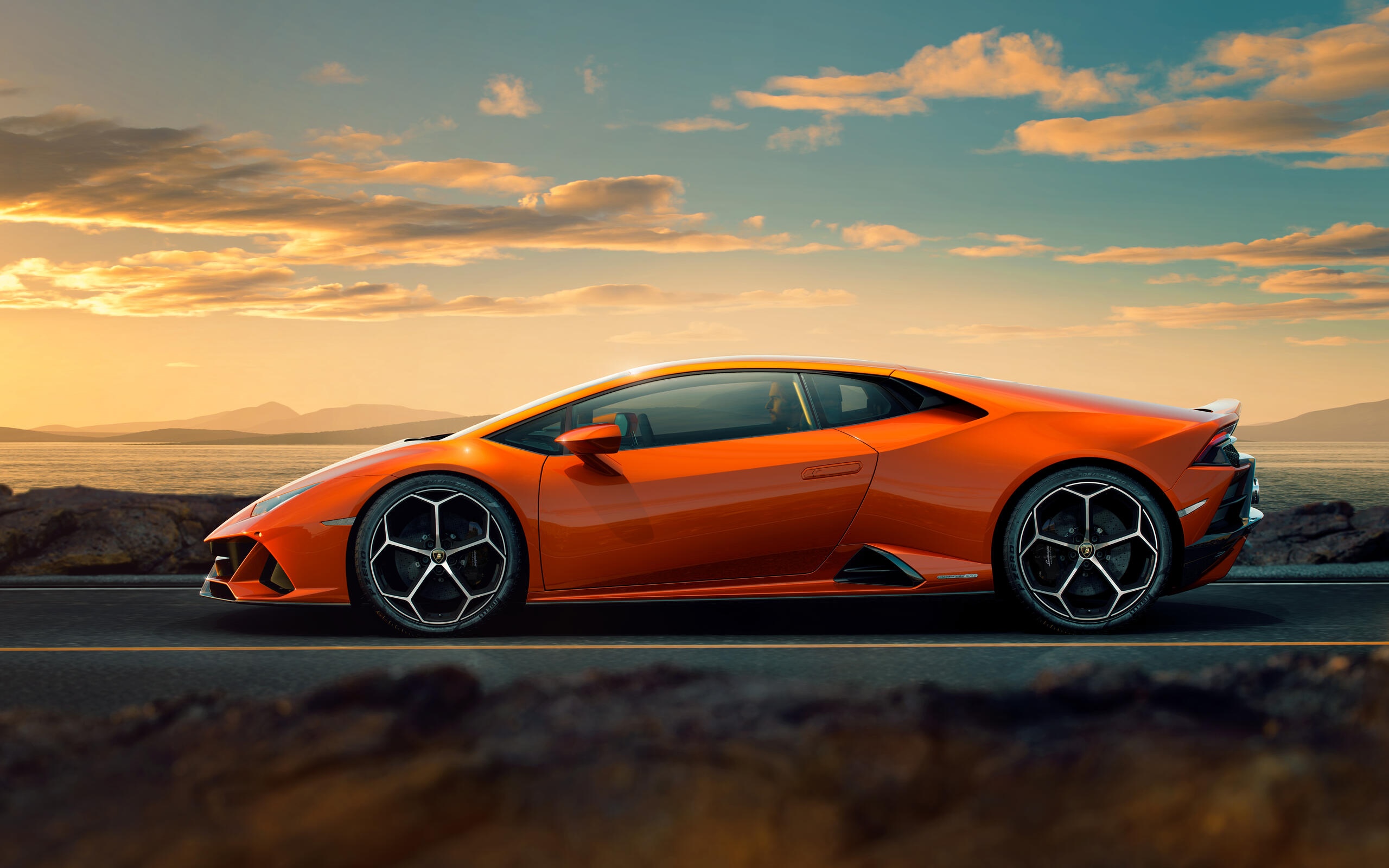 Orange Lamborghini Huracan parked on a road HD Wallpaper