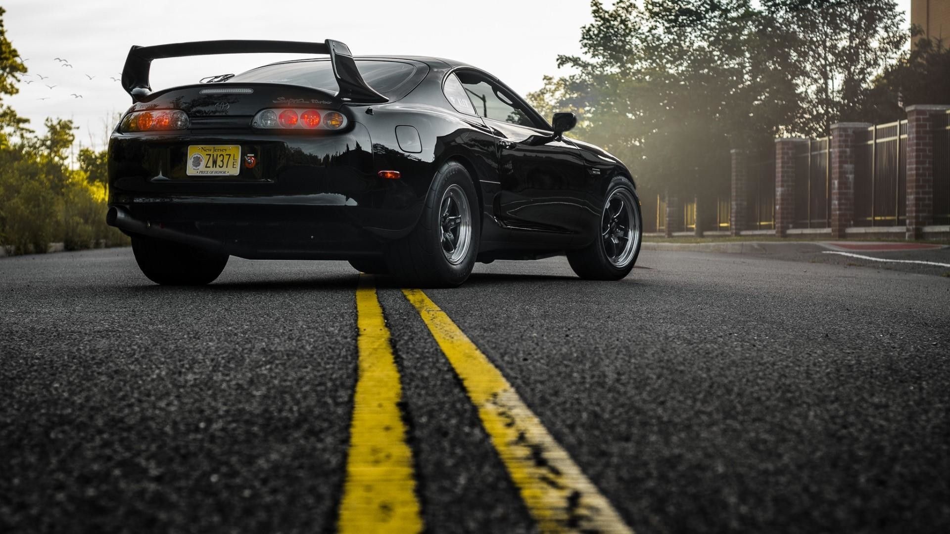 Black Toyota Supra with WELD Racing Rims on Road HD Wallpaper