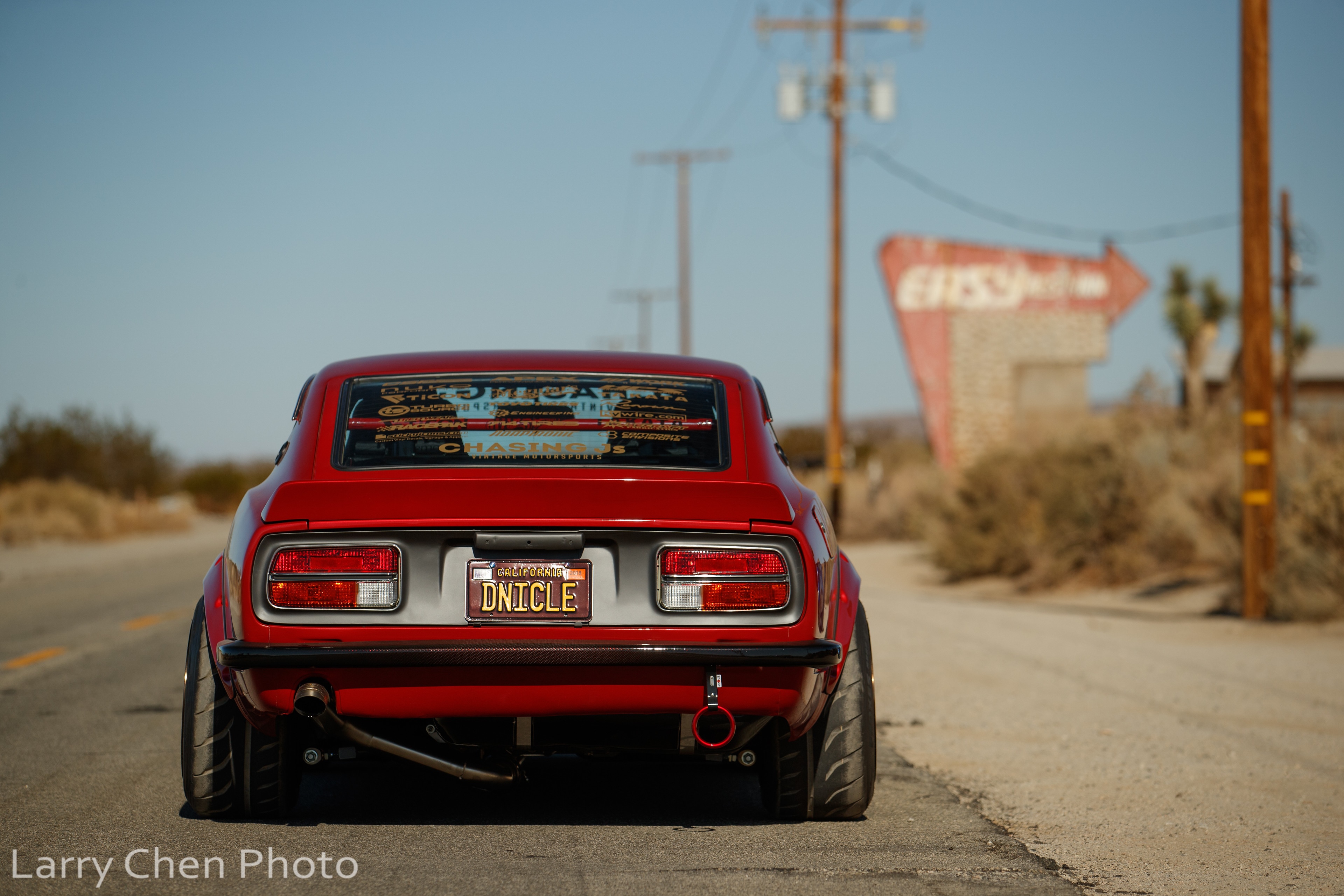 Red Nissan S30 sports car in desert landscape HD Wallpaper
