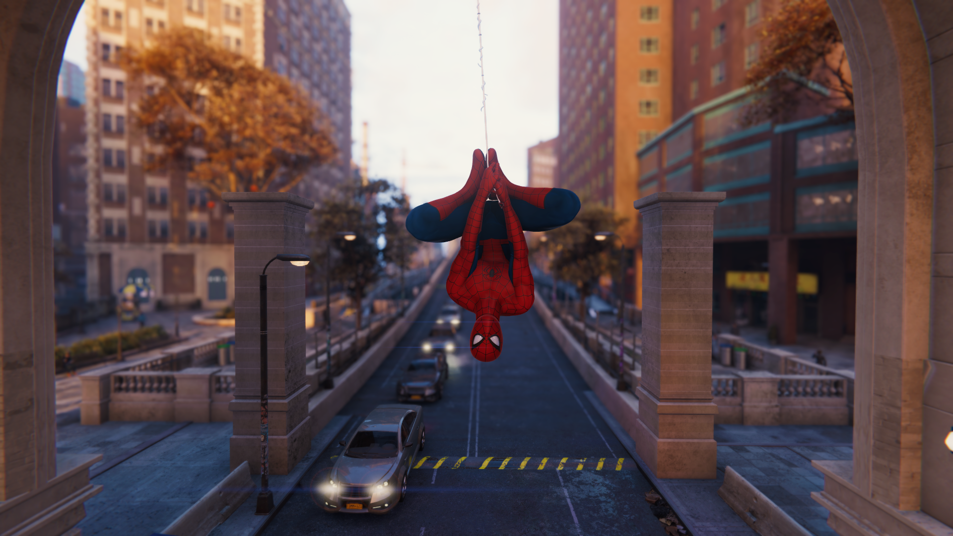 Spider-Man hanging upside down over a street HD Wallpaper