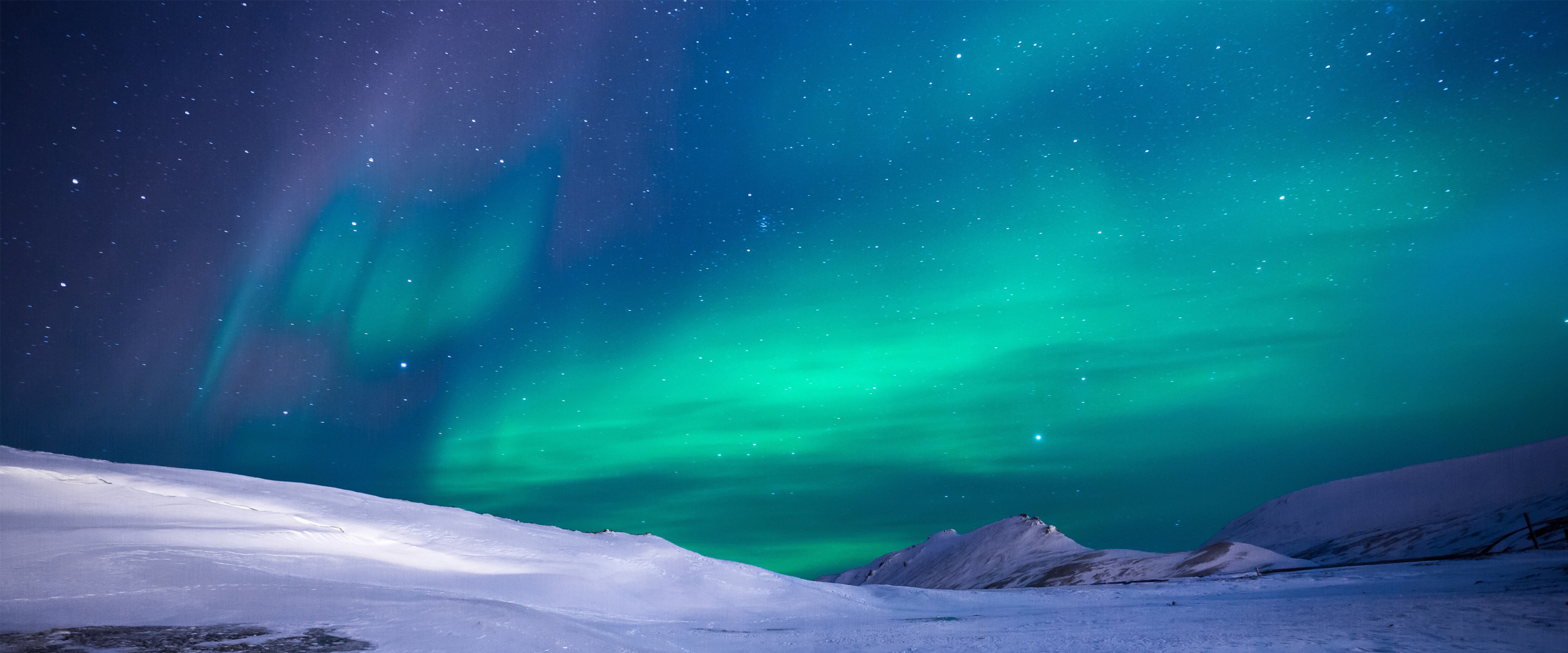 4K Aurora Borealis over snowy landscape HD Wallpaper
