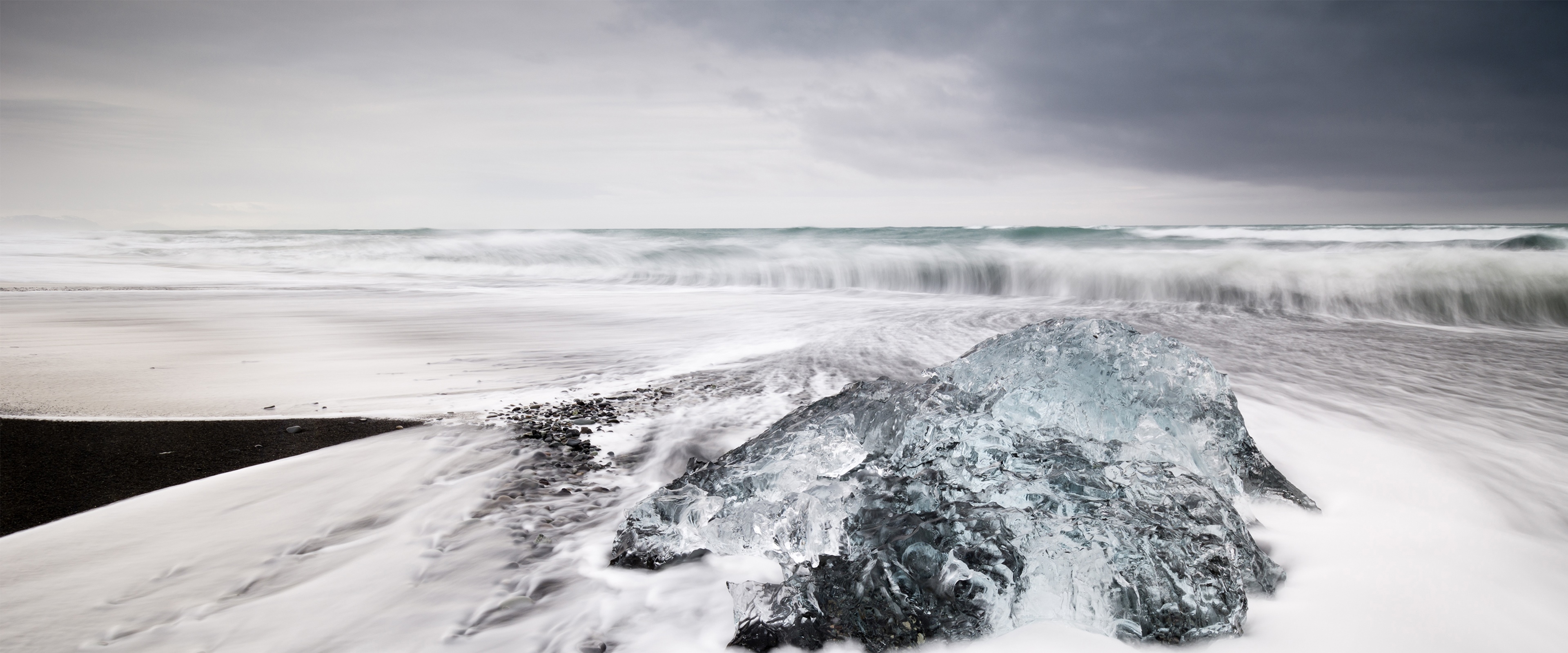 4K landscape of ice on a black sand beach HD Wallpaper
