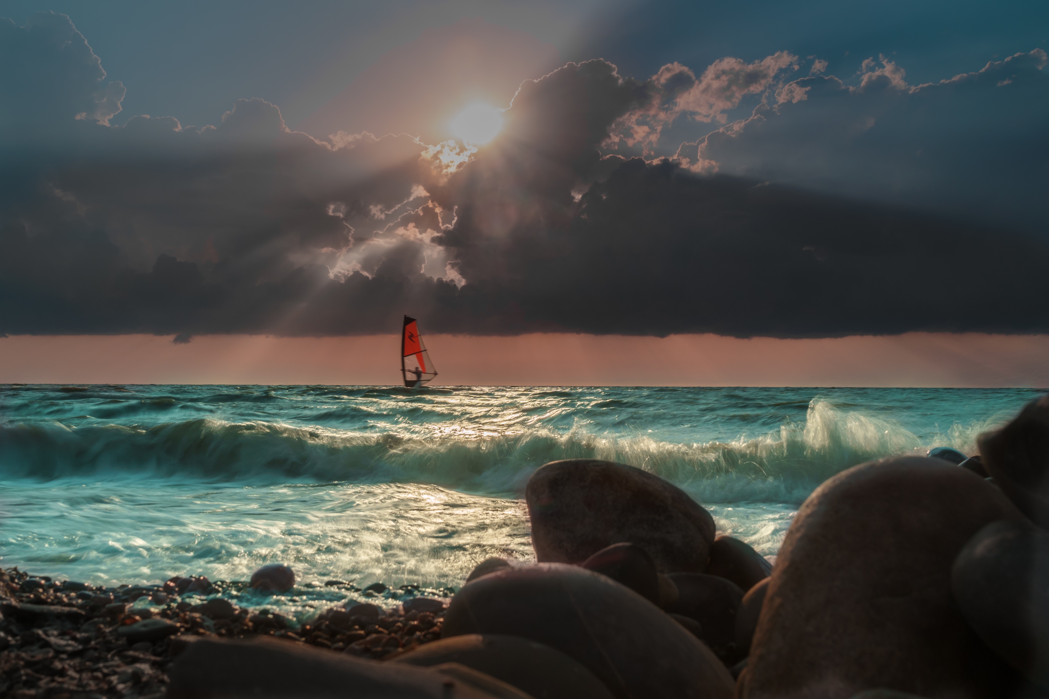 Windsurfer on the sea during sunset with dramatic clouds HD Wallpaper