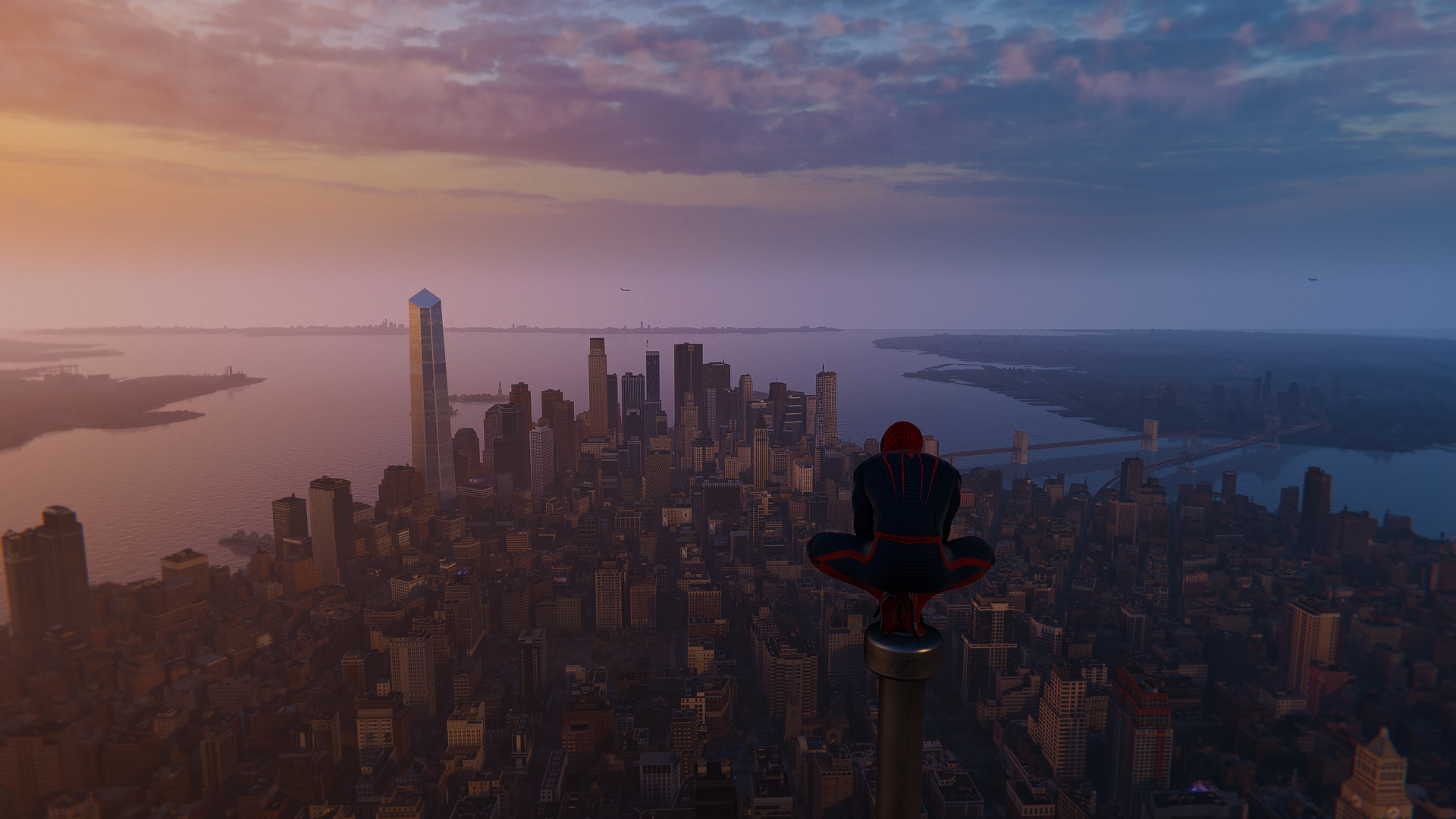 Spider-Man sits atop a building overlooking a city at sunset HD Wallpaper