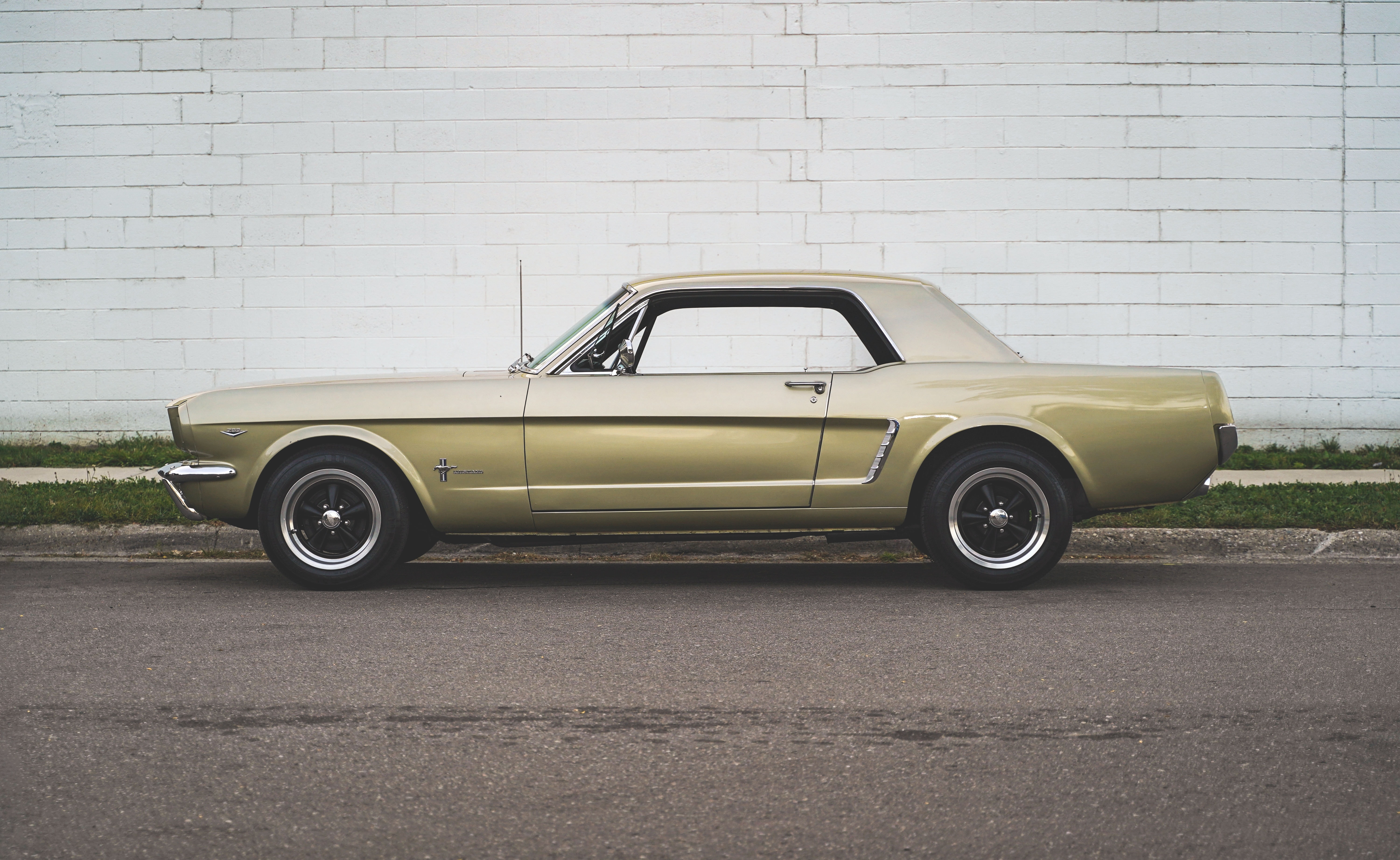 1967 Ford Mustang parked by a white brick wall HD Wallpaper