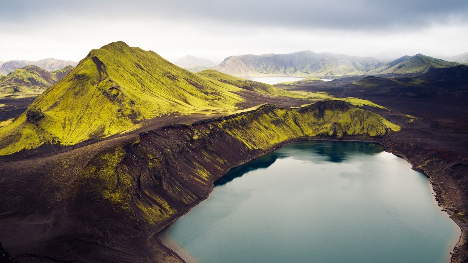 Icelandic landscape with green mountains and a lake HD Wallpaper