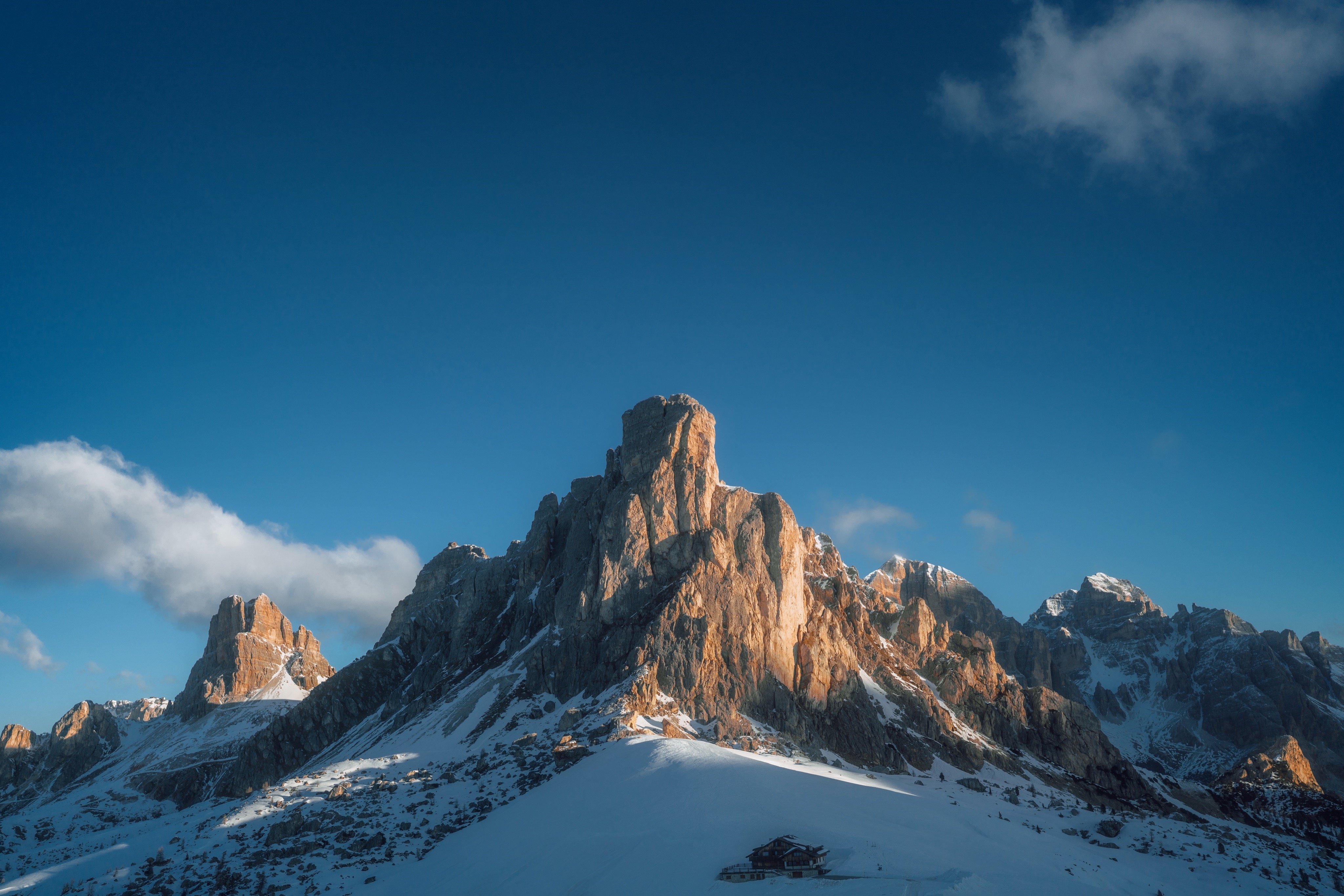 4K snow-covered mountains under a blue sky HD Wallpaper
