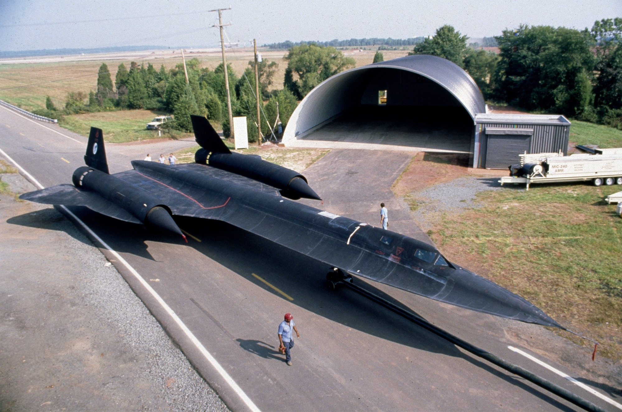 Lockheed SR-71 Blackbird on a road near a hangar HD Wallpaper