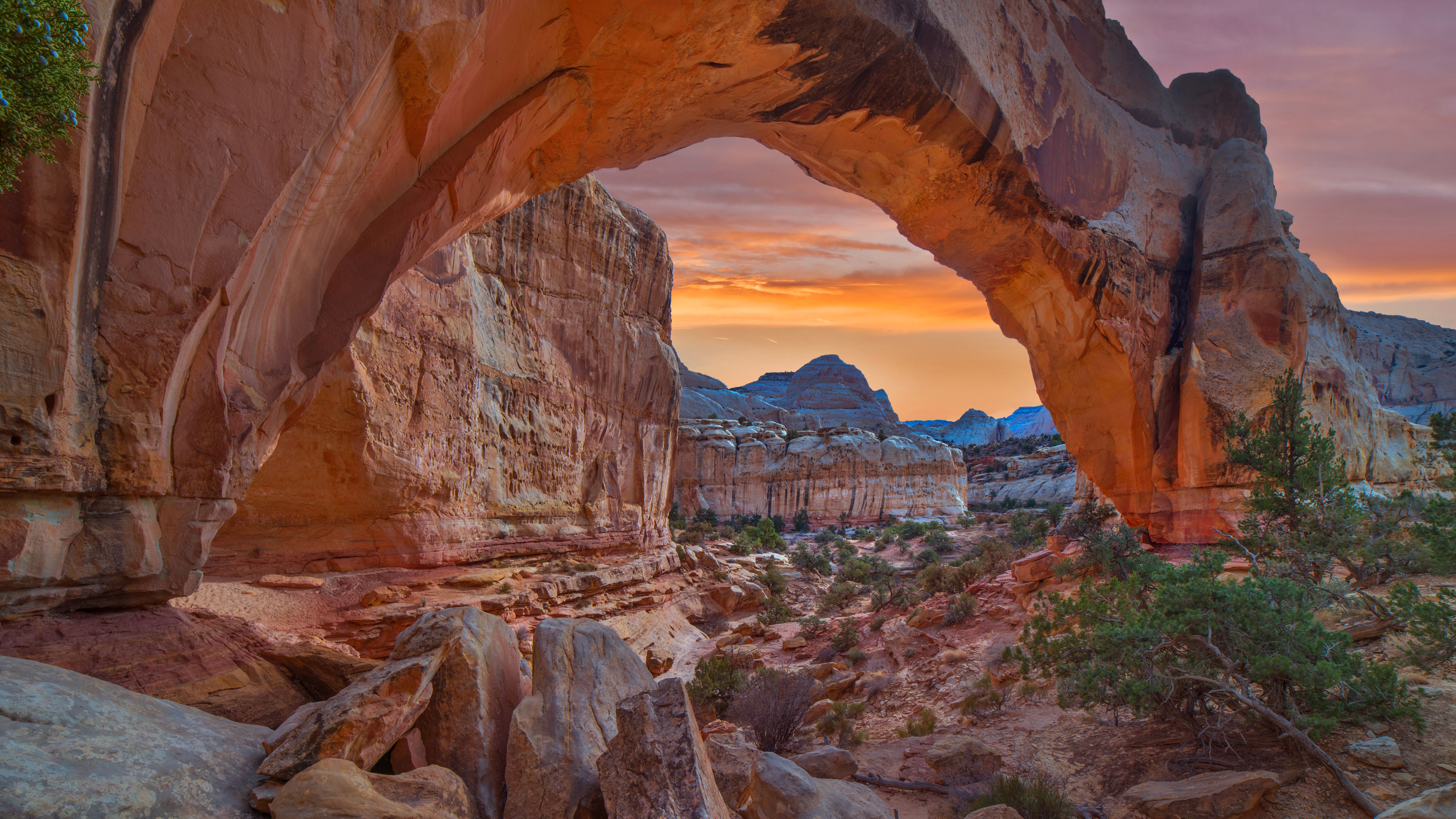 Natural rock arch at sunset in Capitol Reef National Park HD Wallpaper