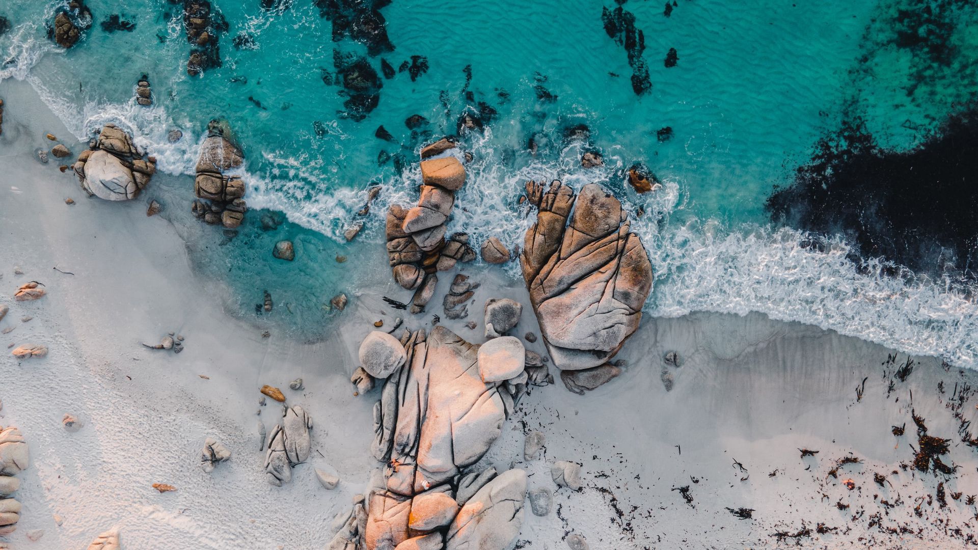Aerial view of a rocky beach with turquoise water HD Wallpaper
