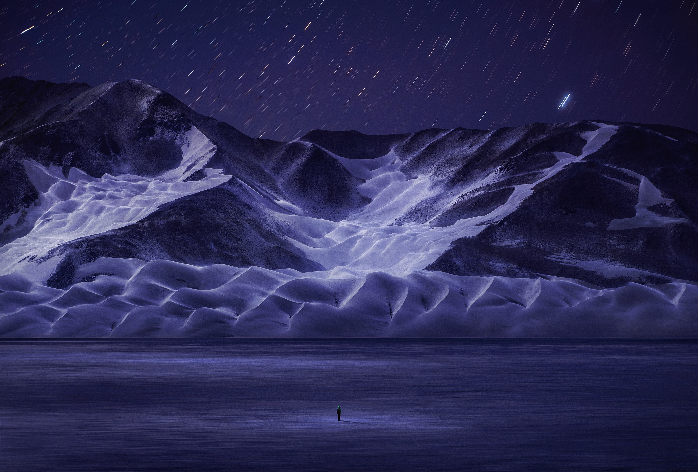 Snowy mountains under starry night sky in China HD Wallpaper