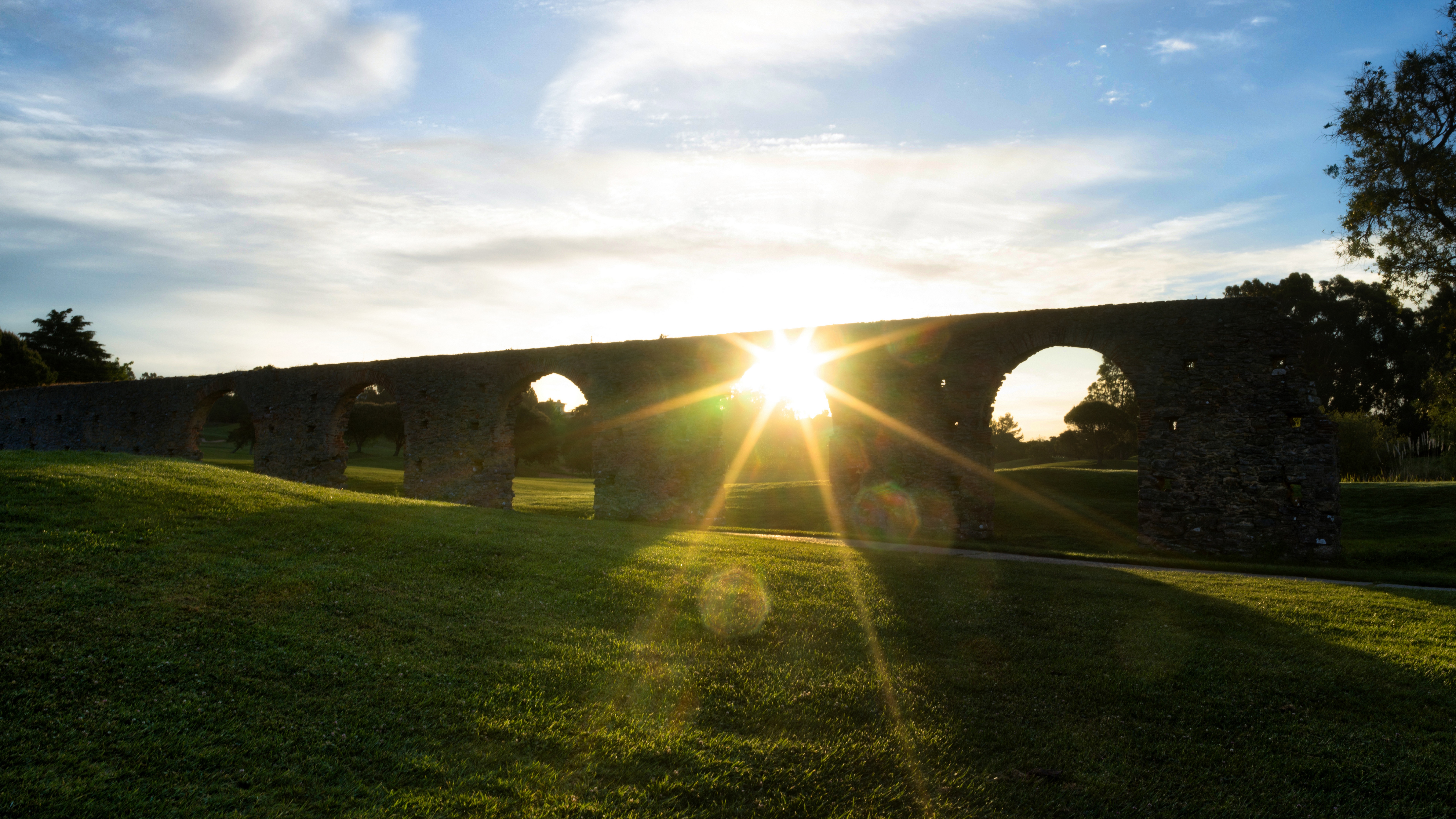 Old stone aqueduct in Lisbon at sunset HD Wallpaper