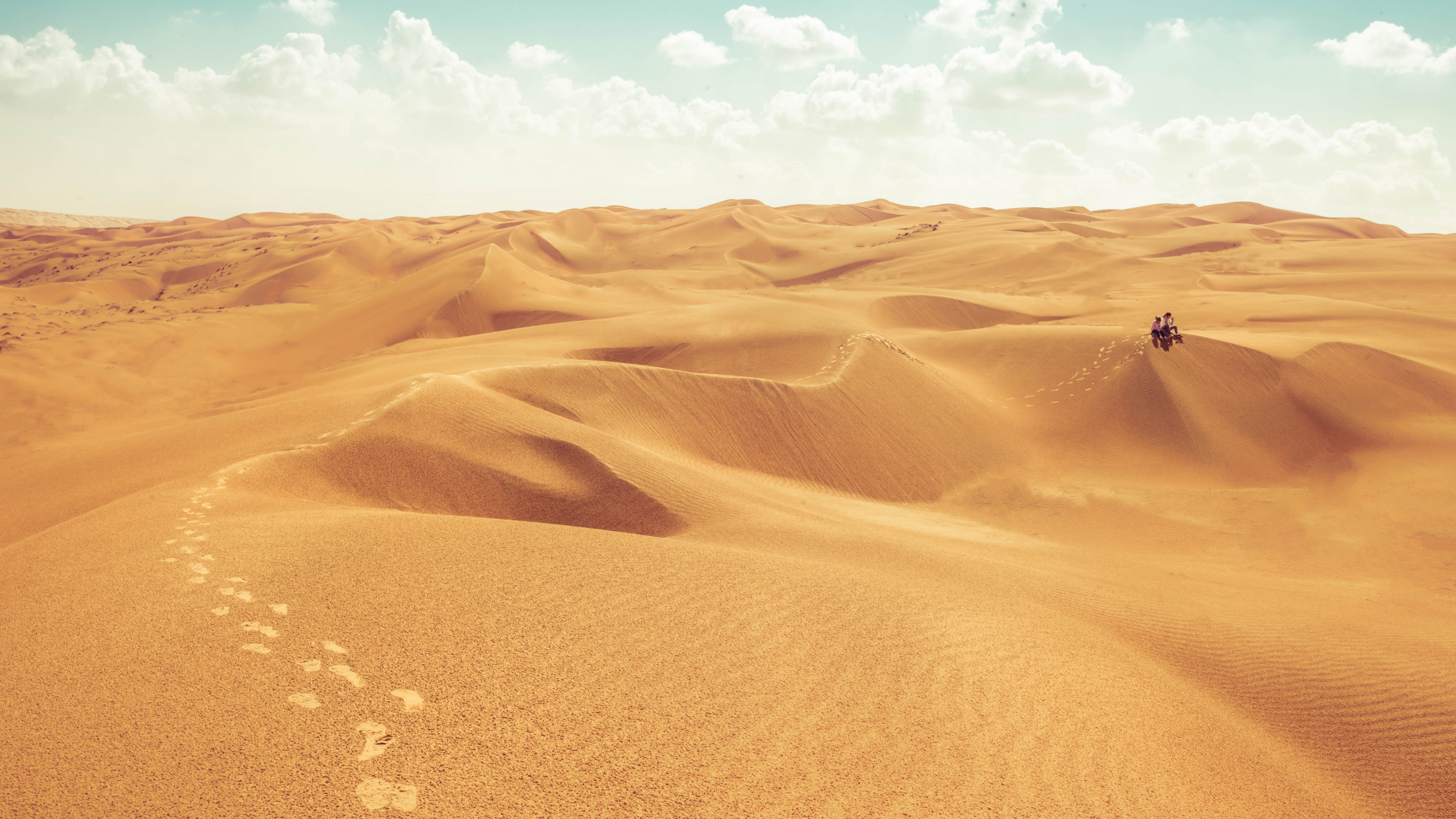 4K Oman Desert Landscape with Footprints and People on ATV HD Wallpaper