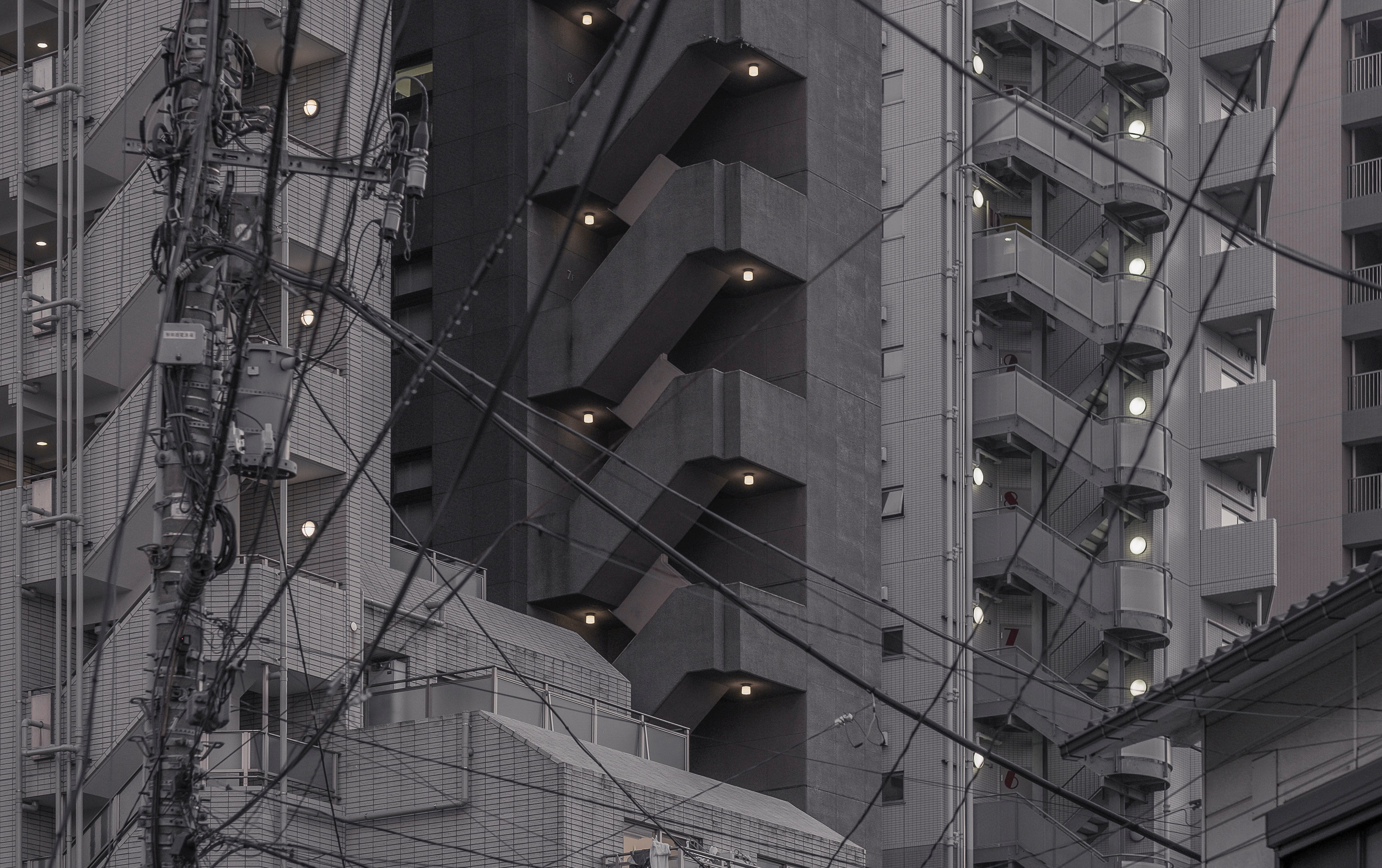 Cityscape with tangled wires and apartment buildings in Japan HD Wallpaper