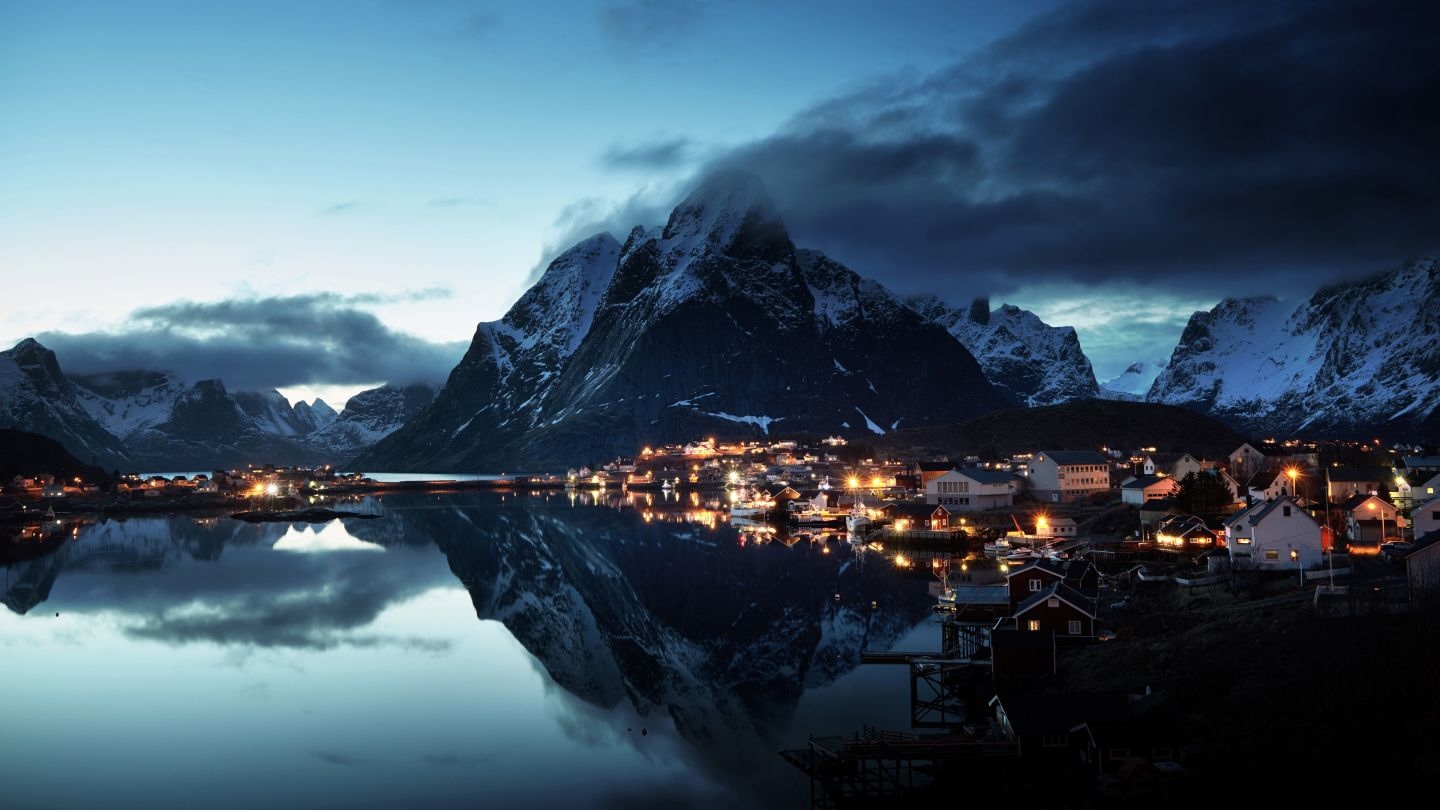 Village lights reflected in water at Lofoten, Norway HD Wallpaper