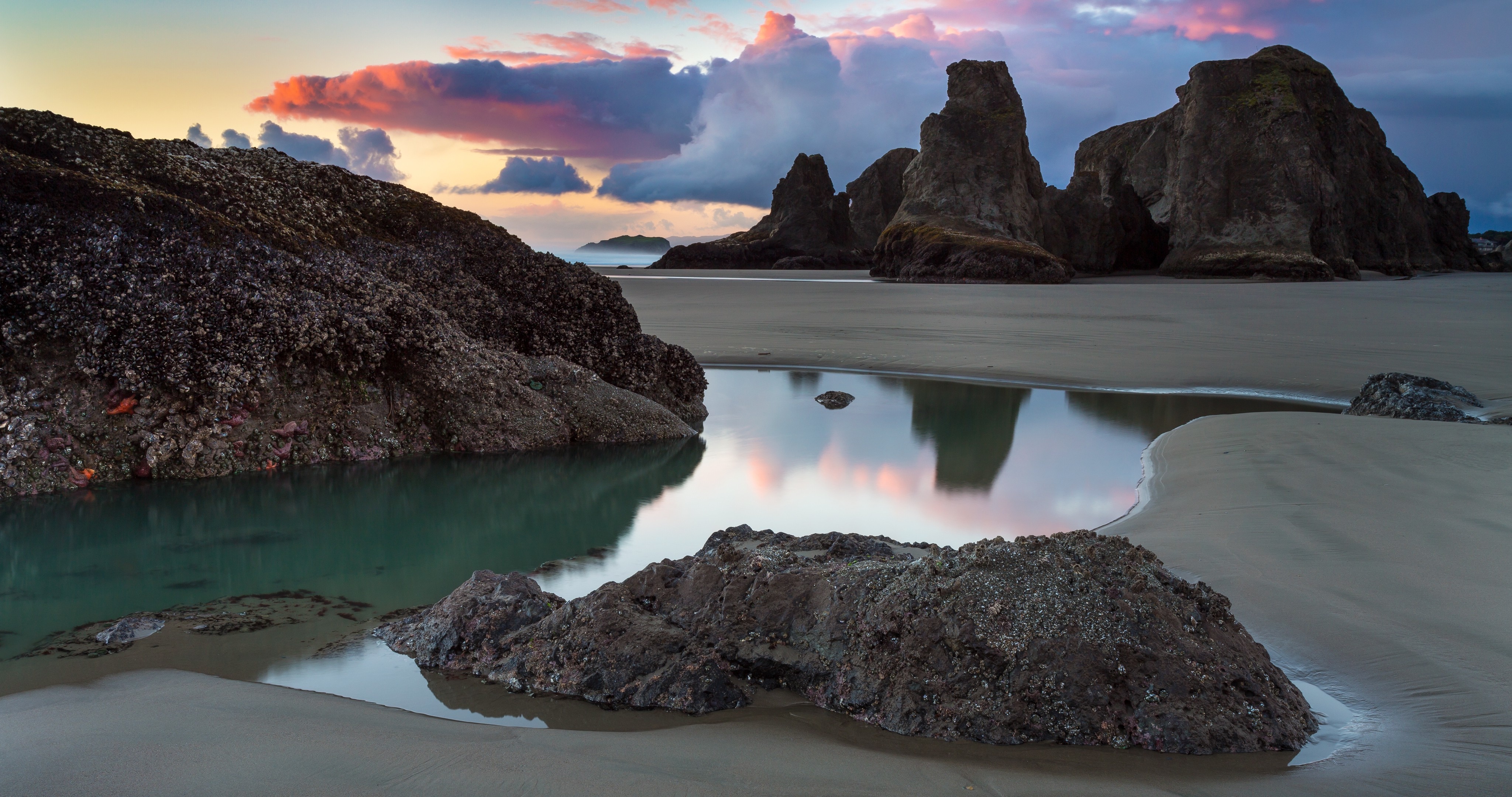 4K beach with rock formations and tide pools at sunset HD Wallpaper