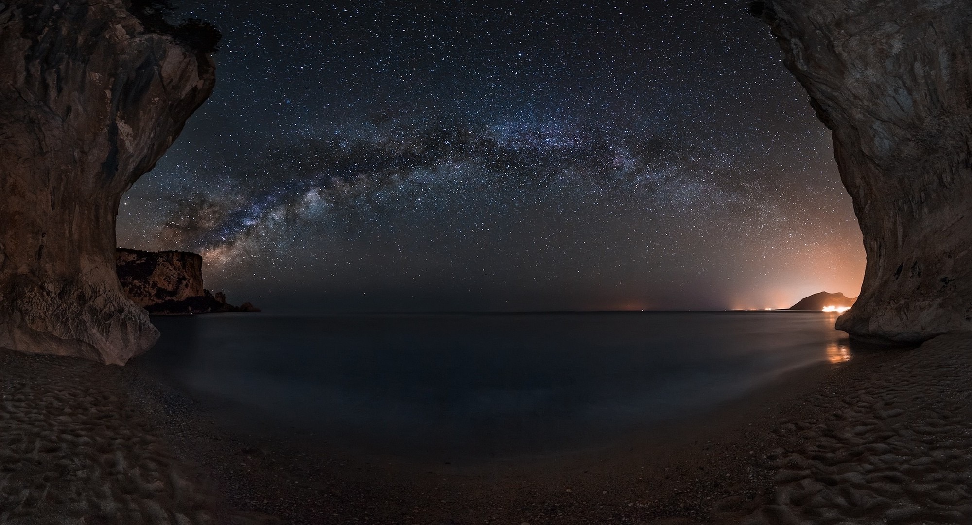 Milky Way over a rocky coastline at night HD Wallpaper