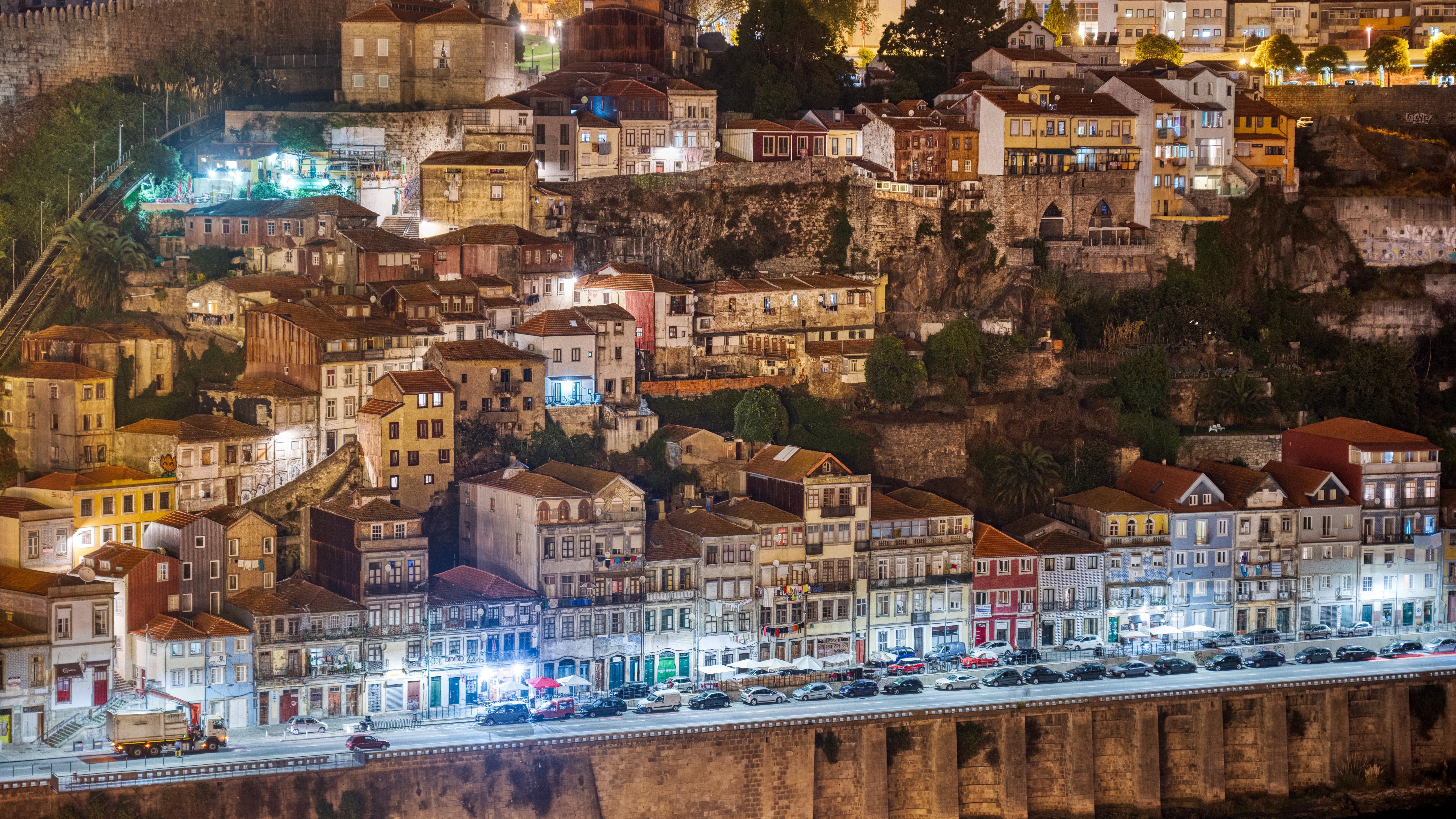 Cityscape at night with buildings and cars HD Wallpaper