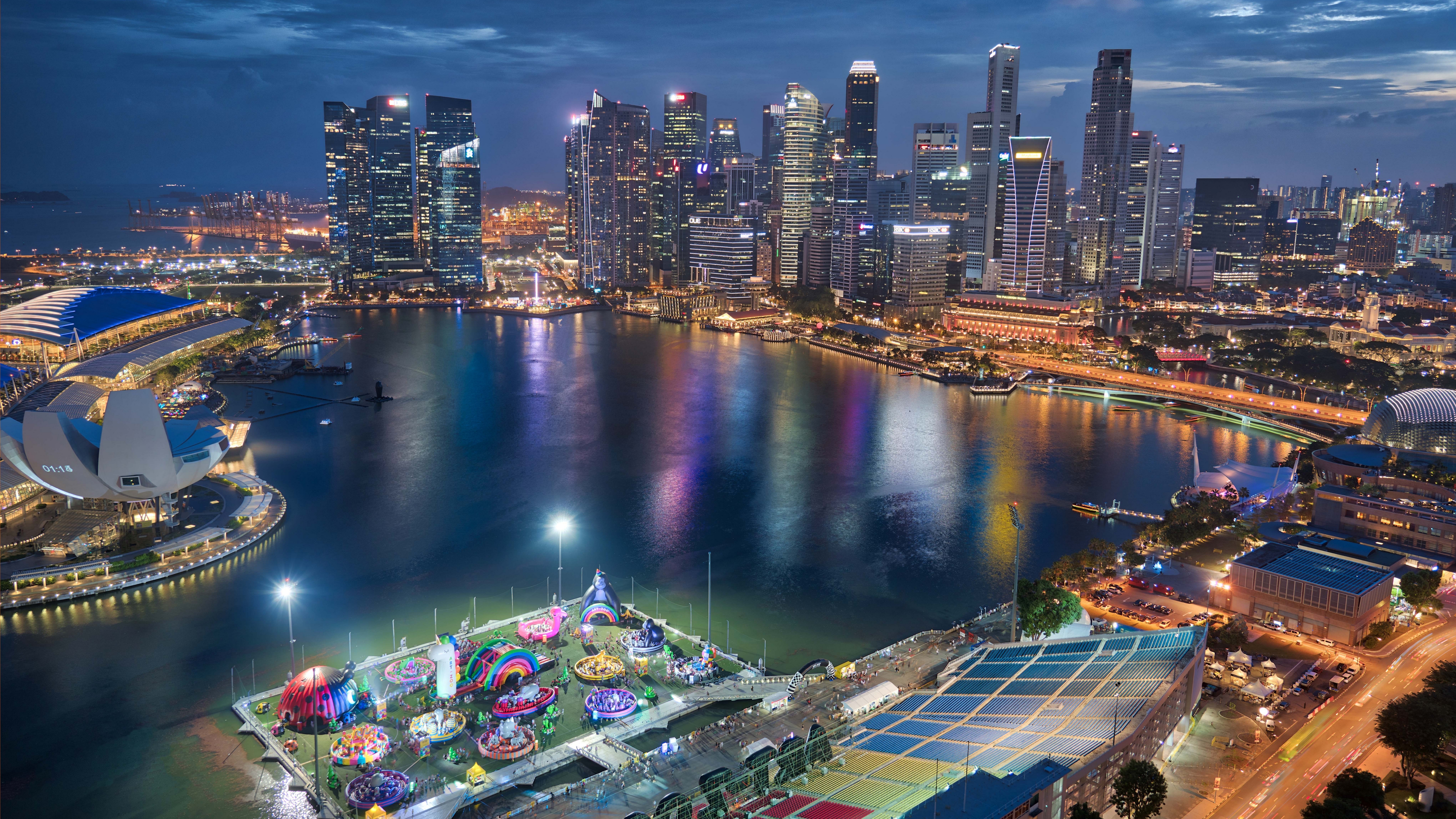 4K Singapore cityscape with skyscrapers and water at night HD Wallpaper