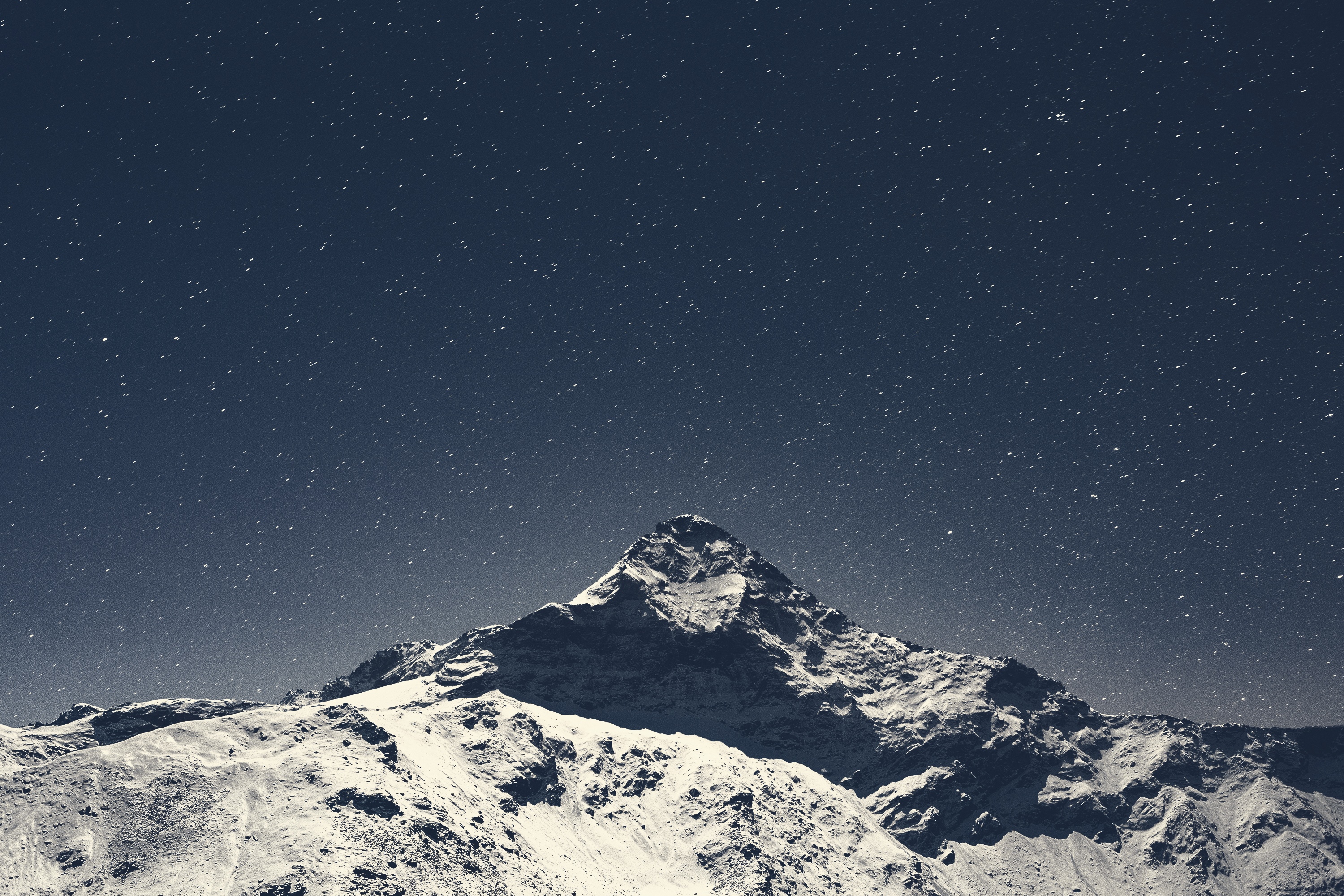 Snowy mountain peak under a starry night sky HD Wallpaper