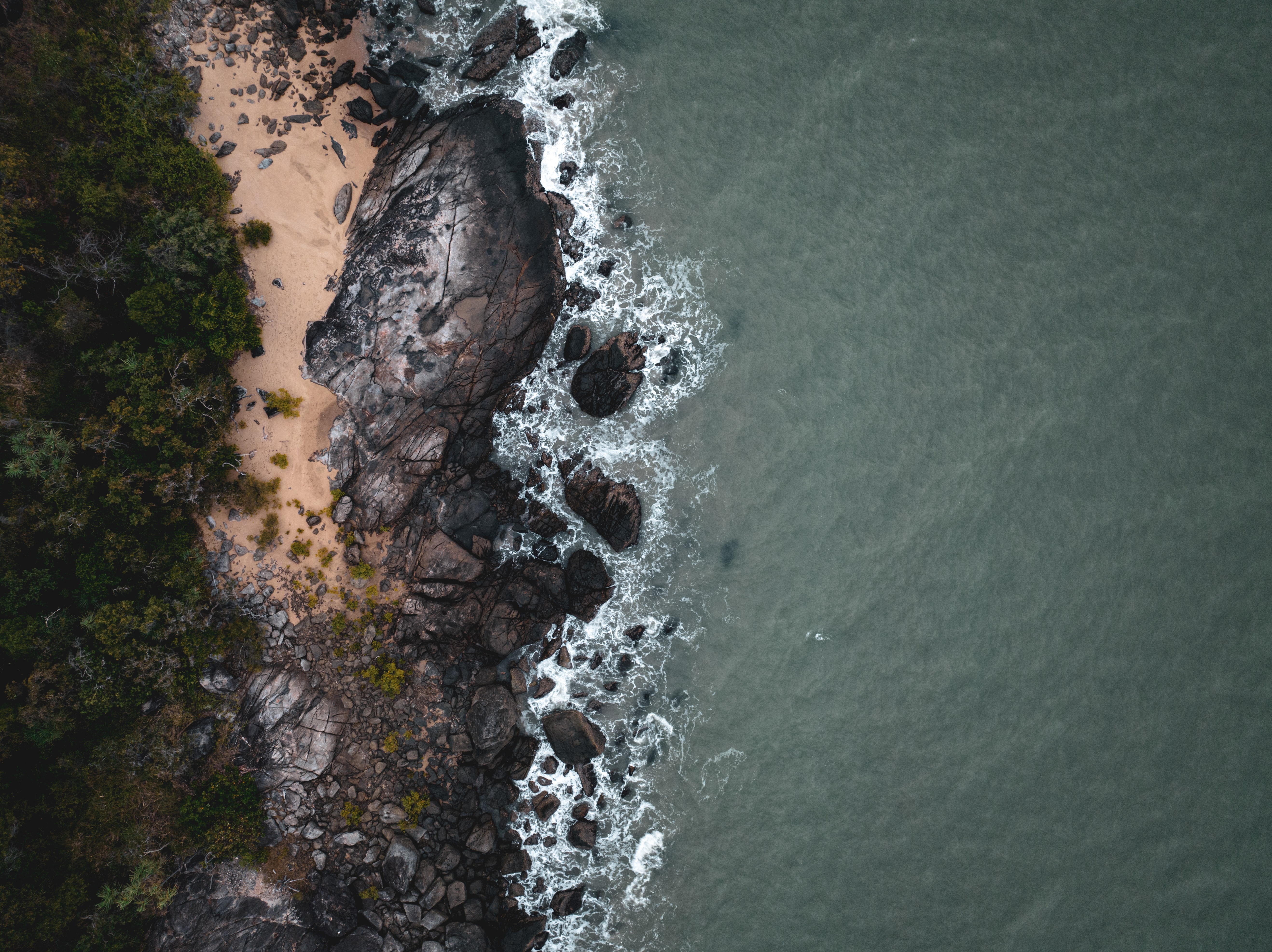 4K Aerial view of rocky coastline and ocean HD Wallpaper