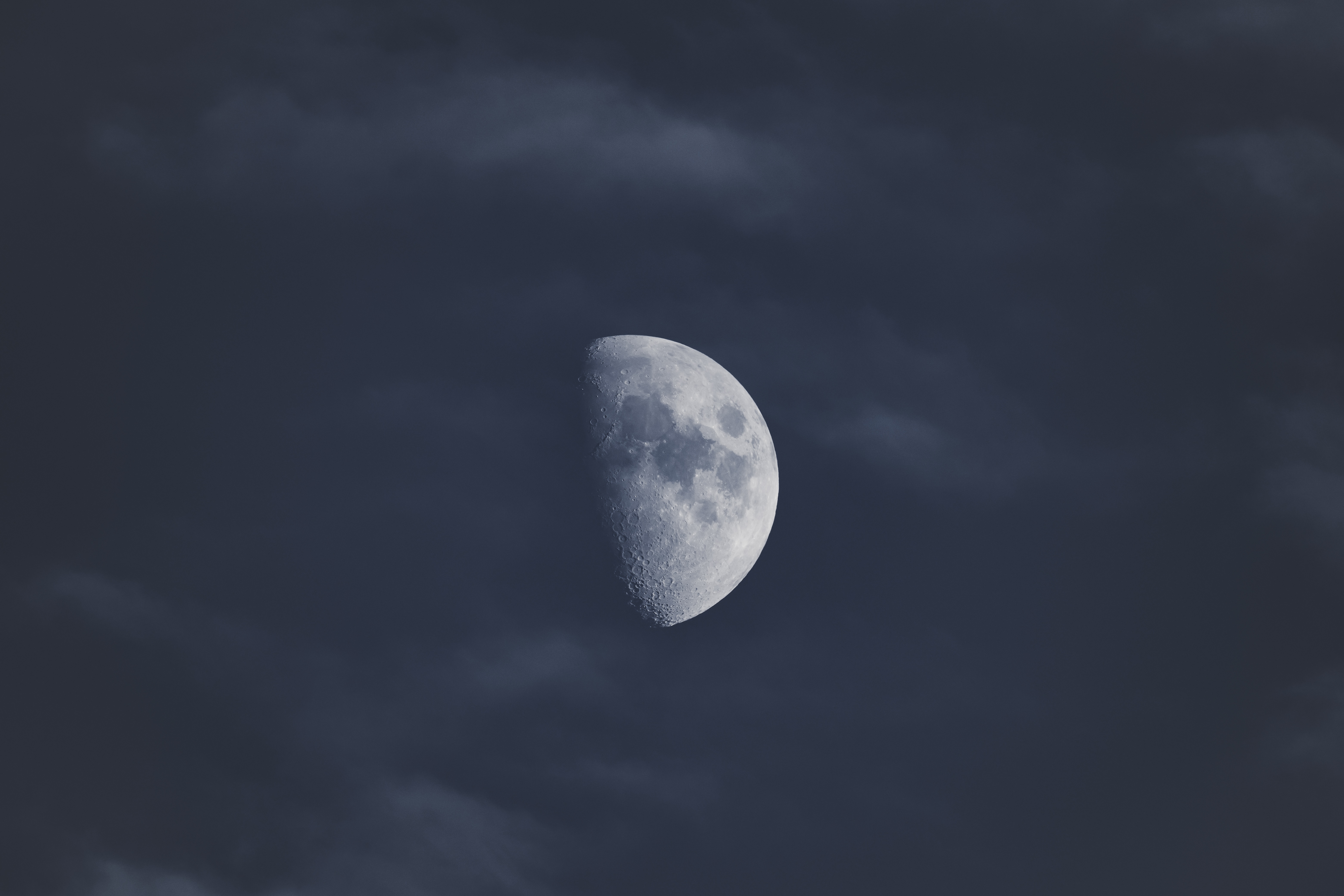 4K Moon in a cloudy blue sky HD Wallpaper